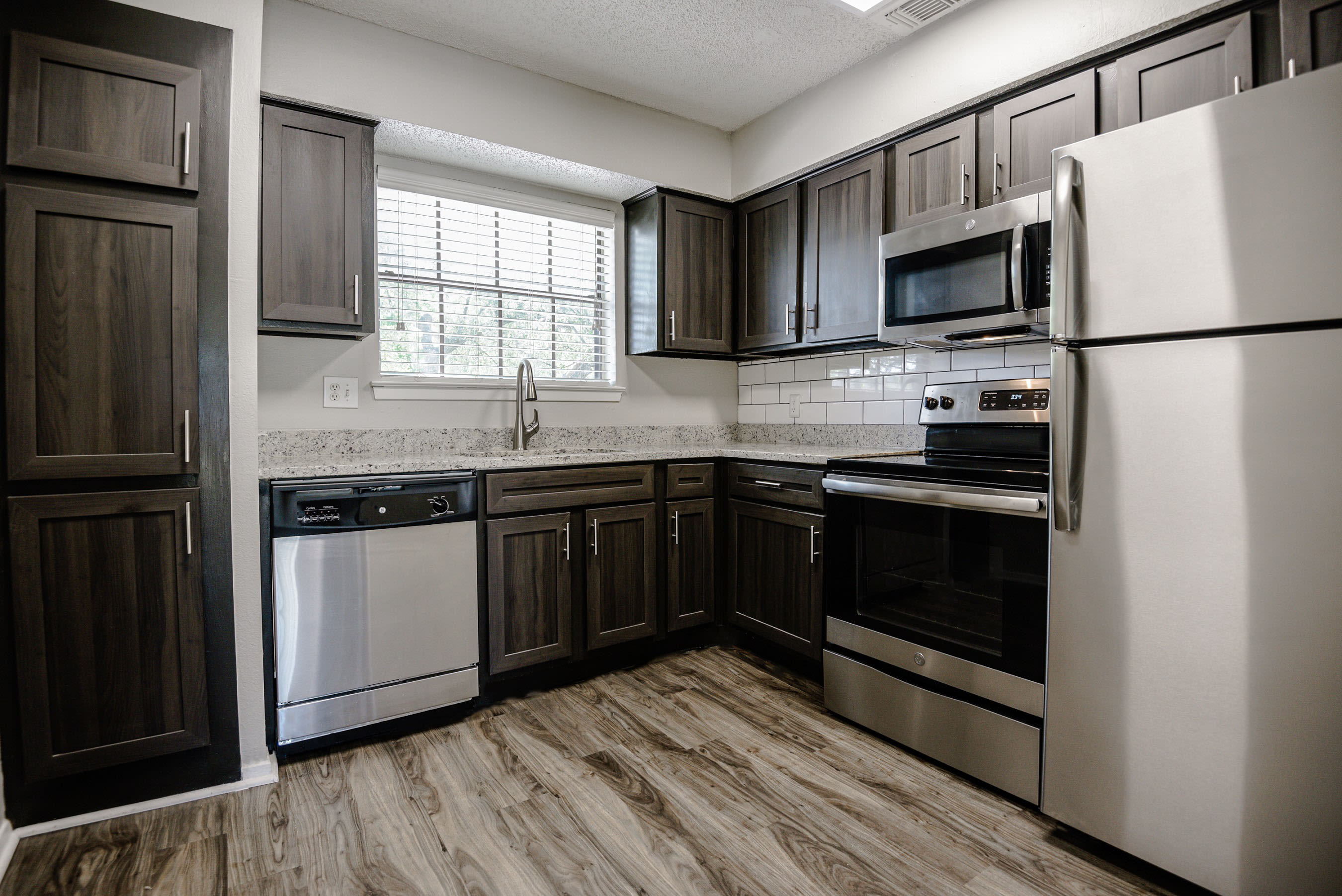 Kitchen with plenty of counter space and stainless-steel appliances at The Regent in Dallas, Texas