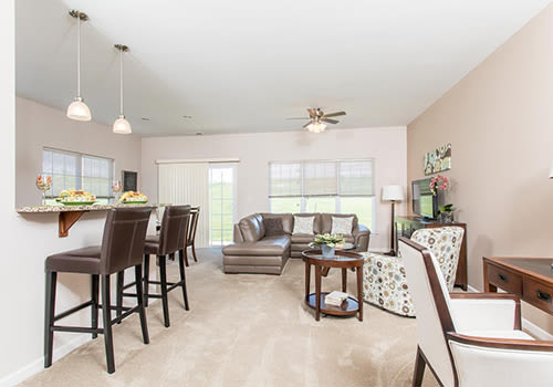 Bright, spacious living room at Preserve at Autumn Ridge in Watertown, New York