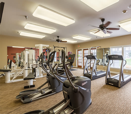 Fully equipped fitness center at Oakmonte Apartments in Webster, New York
