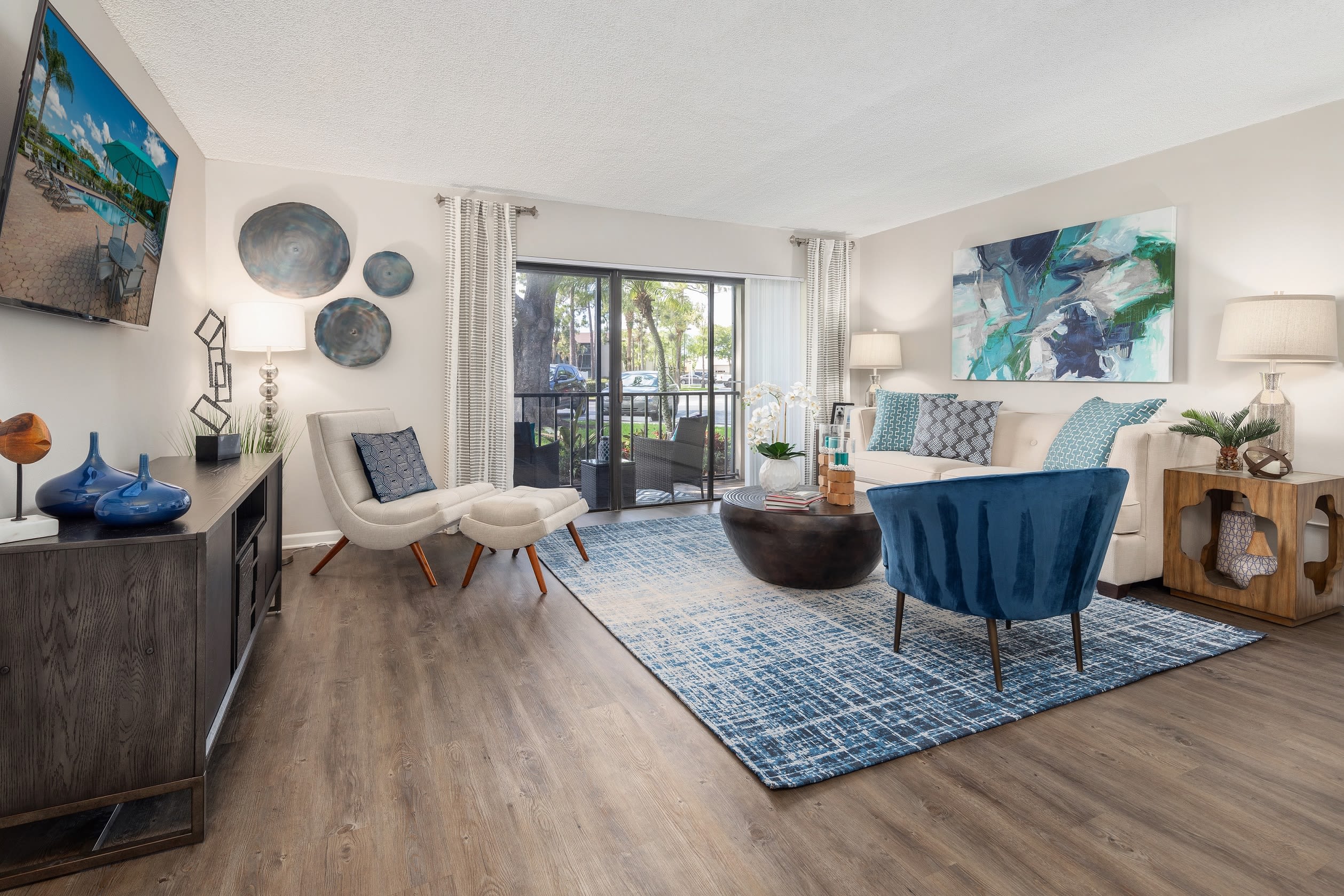 Open concept floor plan with hardwood floors and modern decor at Verse at Royal Palm Beach in Royal Palm Beach, Florida