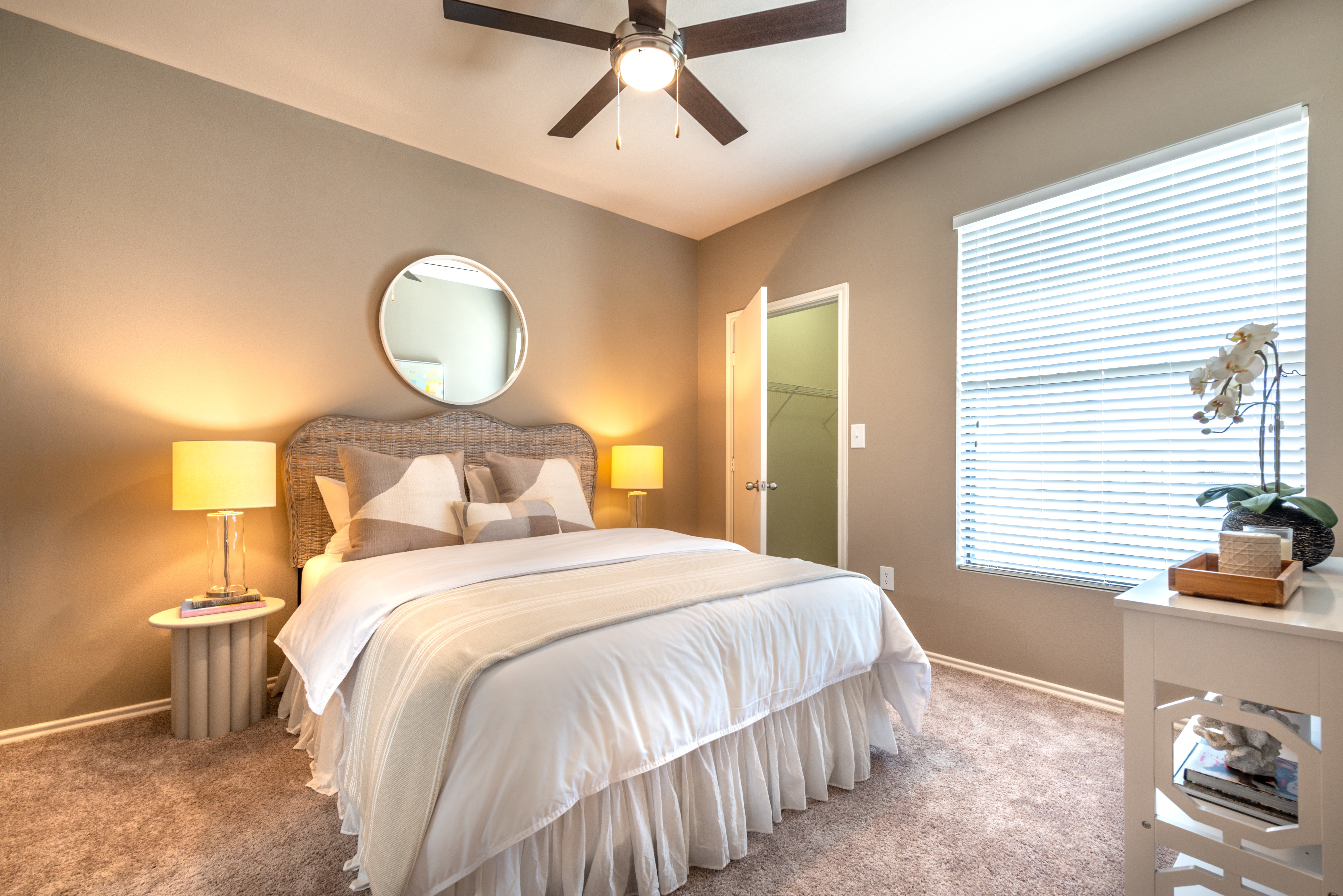 Accent wall and walk-in closet in a model home's bedroom at Olympus Team Ranch in Benbrook, Texas