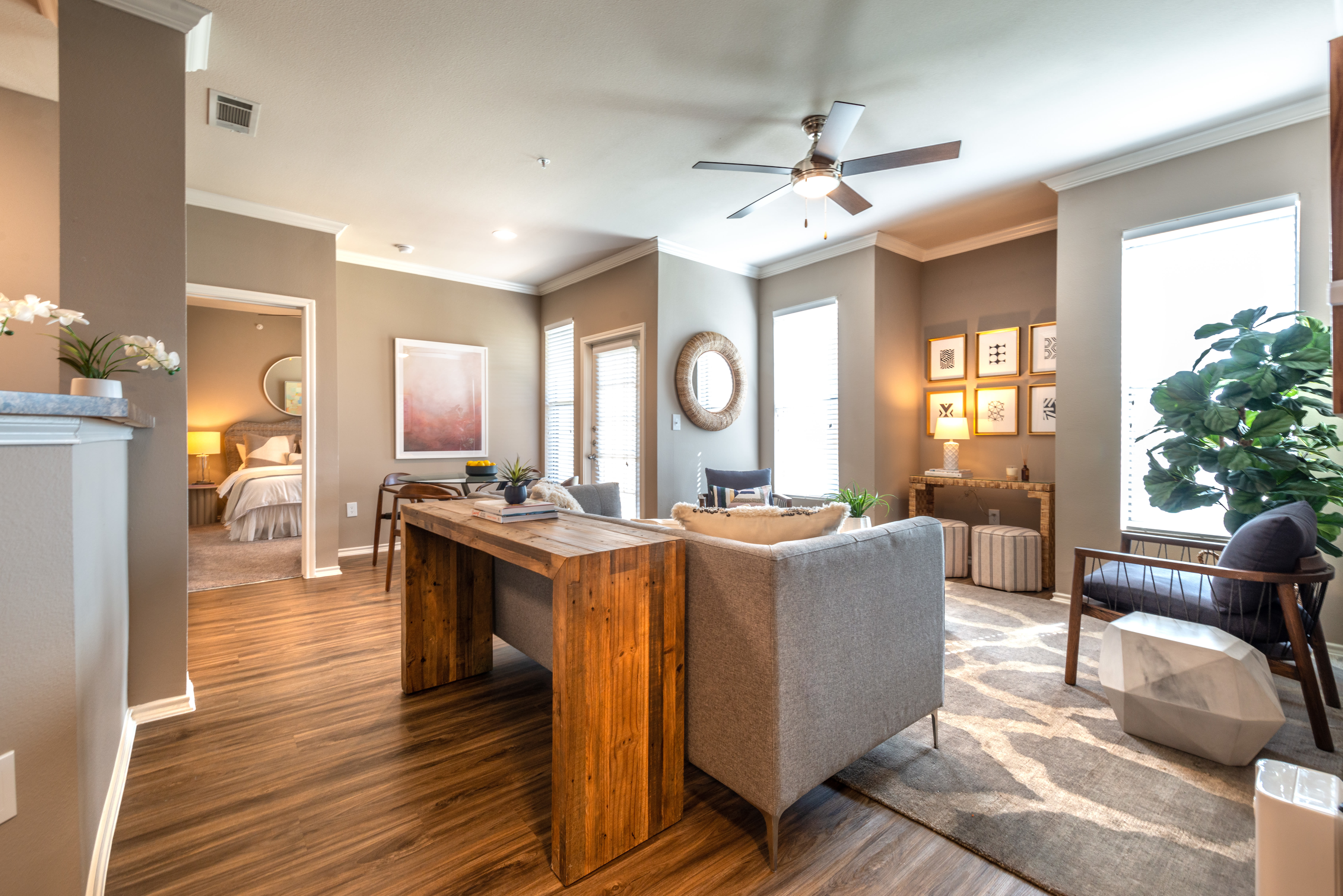 Crown molding and a ceiling fan in the living space of a model home at Olympus Team Ranch in Benbrook, Texas