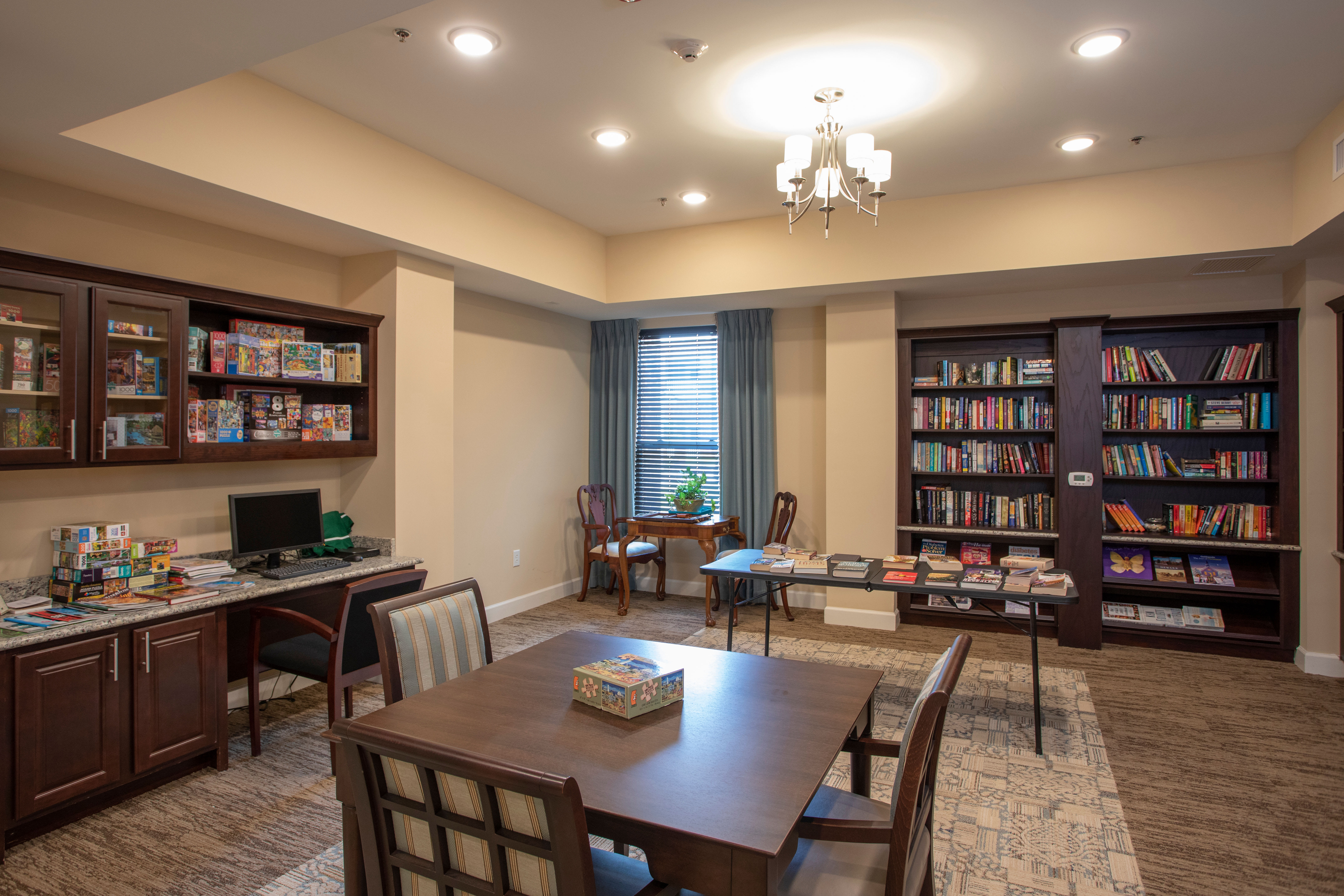 Library area surrounded by bookshelves filled with books at The Harmony Collection at Columbia in Columbia, South Carolina