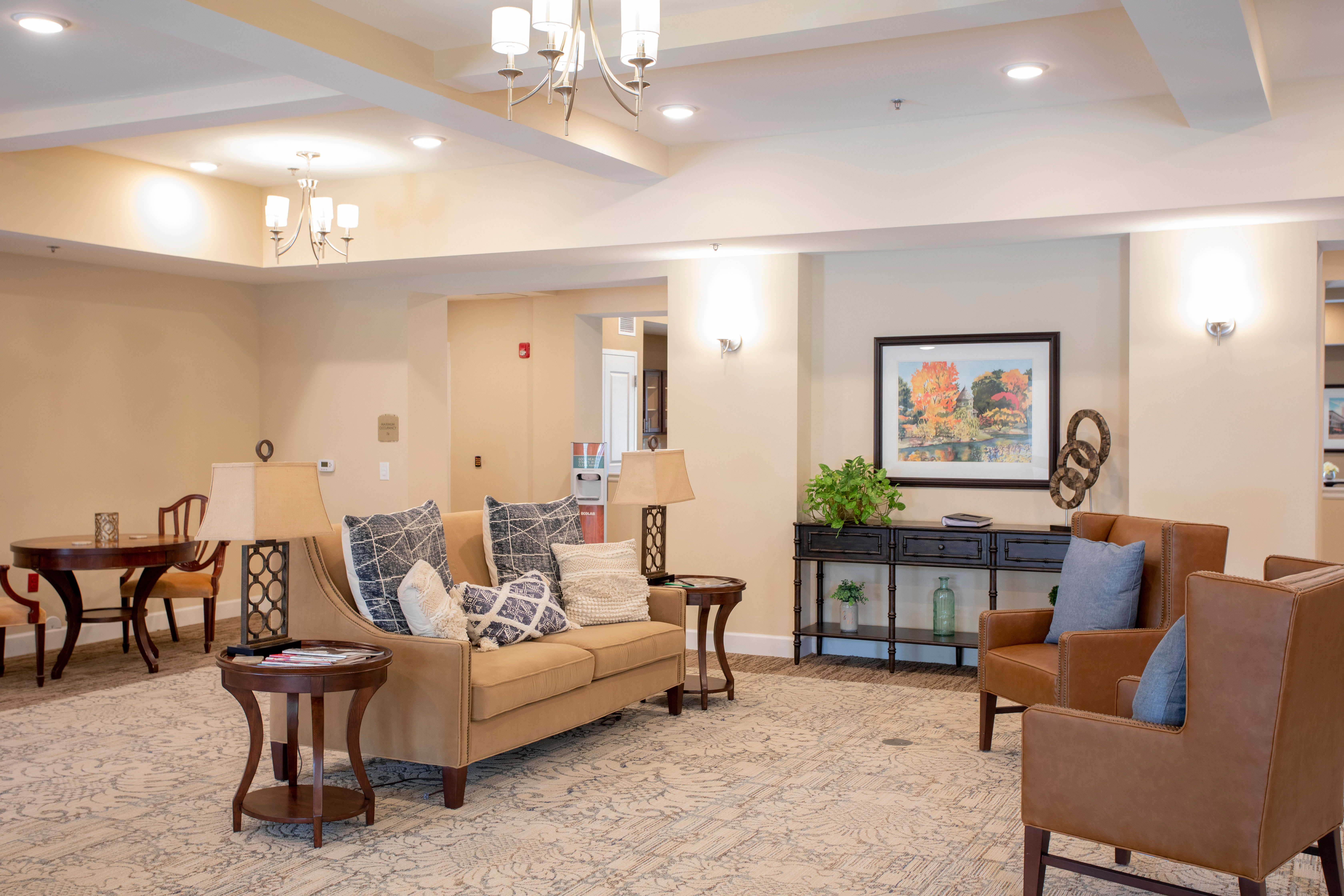 An indoor common area with couch and armchairs at The Harmony Collection at Columbia in Columbia, South Carolina