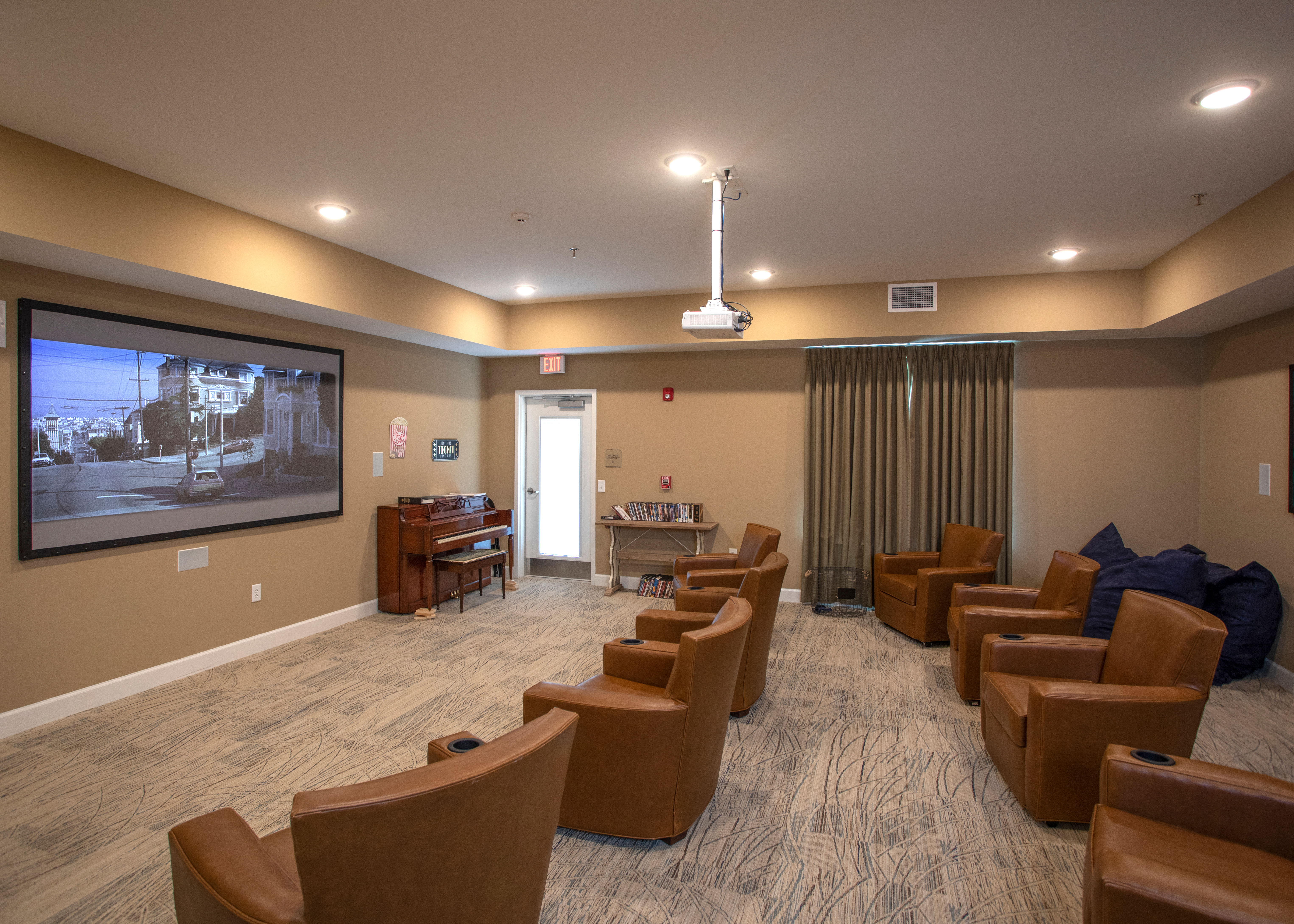 A home theatre with a large screen and projector at The Harmony Collection at Columbia in Columbia, South Carolina