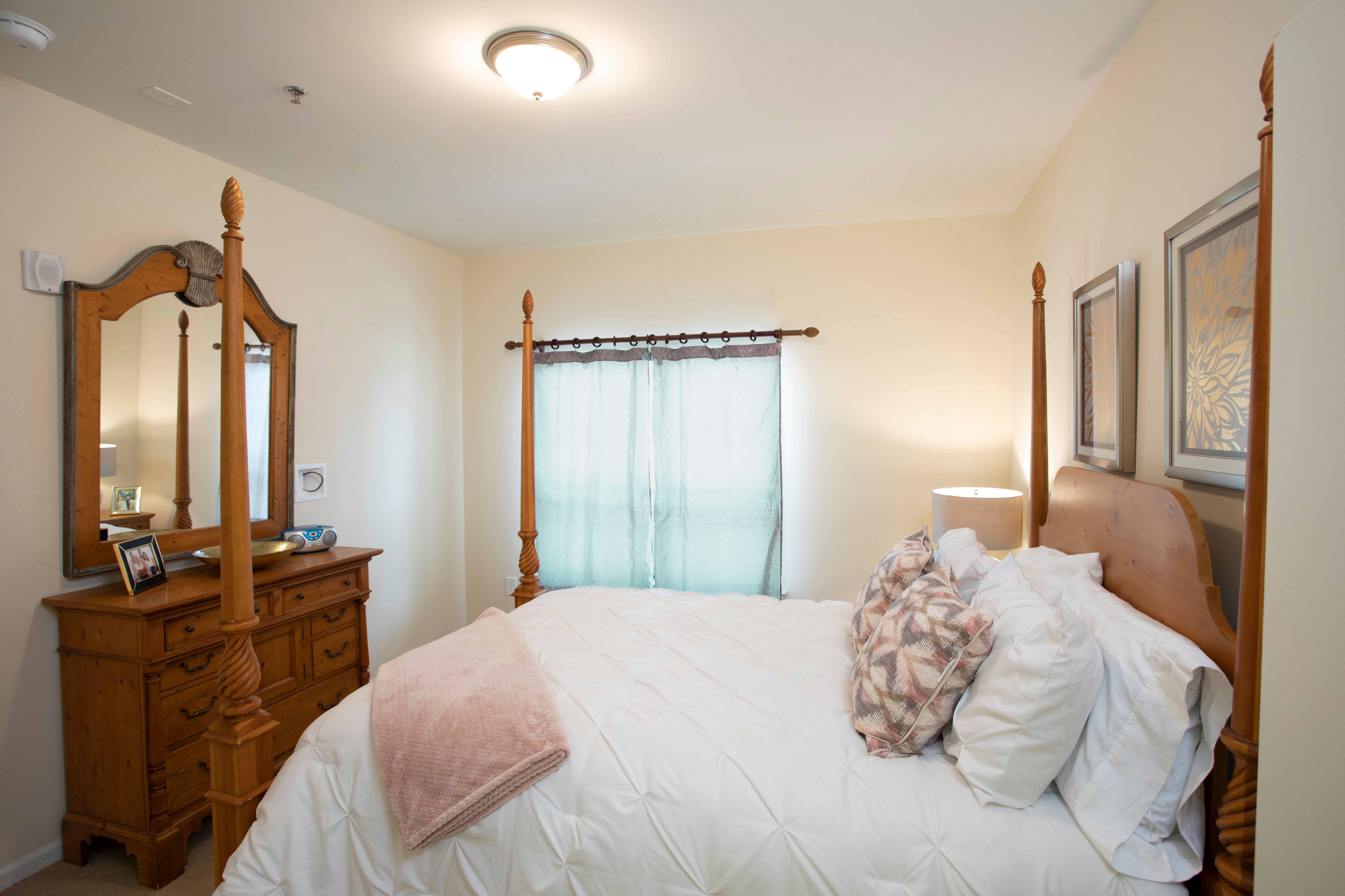 Bedroom with wooden dressing table and window at The Harmony Collection at Columbia in Columbia, South Carolina