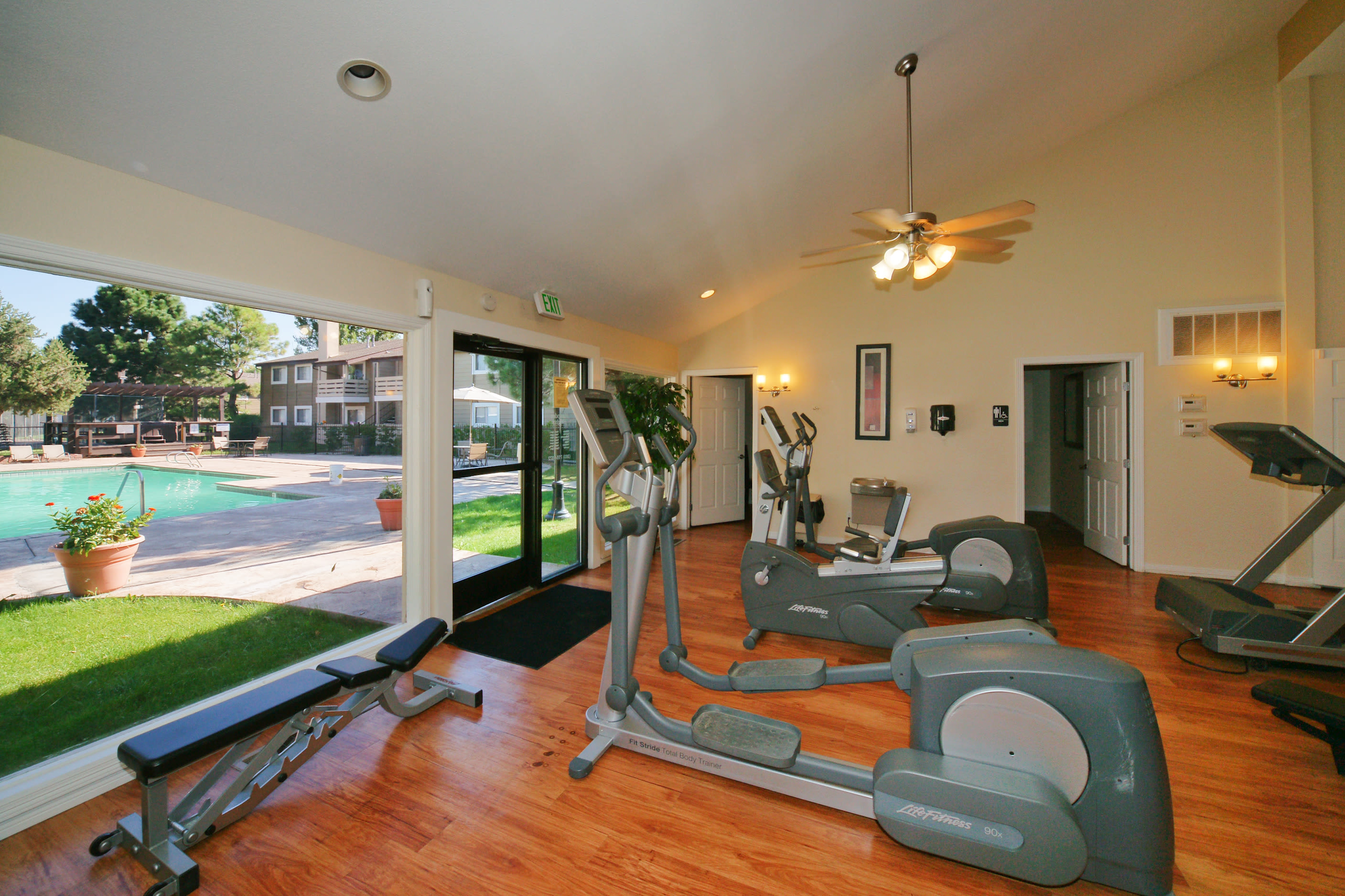 Exercise equipment in fitness center with a tall ceiling at Hampden Heights Apartments in Denver, Colorado 