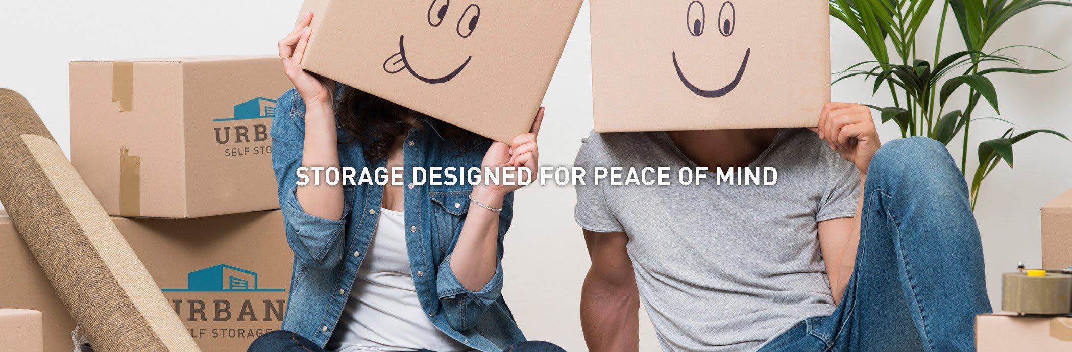 A couple having fun with boxes after they were done packing their things to be stored at Urban Storage on Bennett in Bellingham, Washington