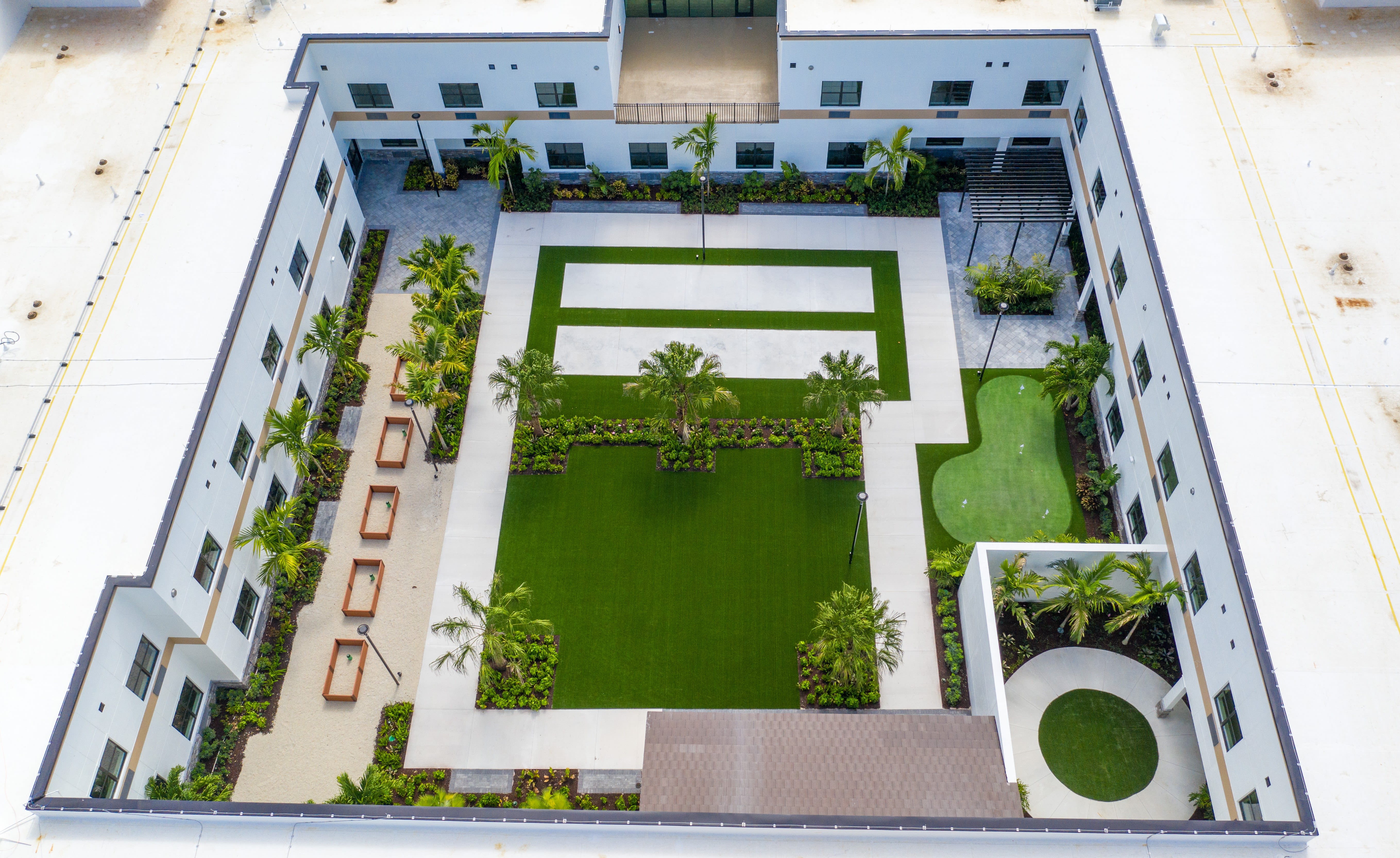 Overhead angle of courtyard and amenities at Inspired Living Royal Palm Beach in Royal Palm Beach, Florida.