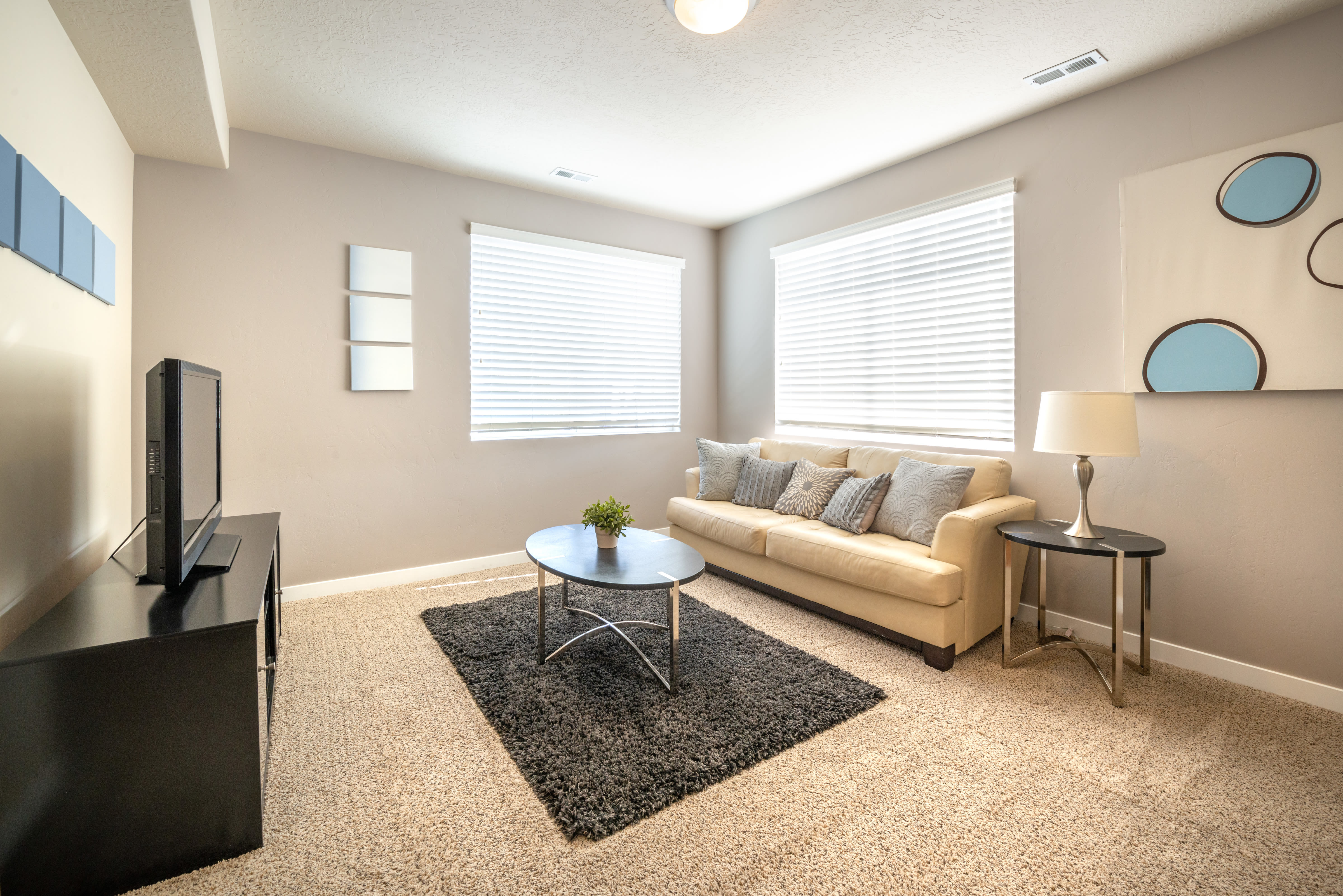 Well-lit living room at Olympus at the District in South Jordan, Utah