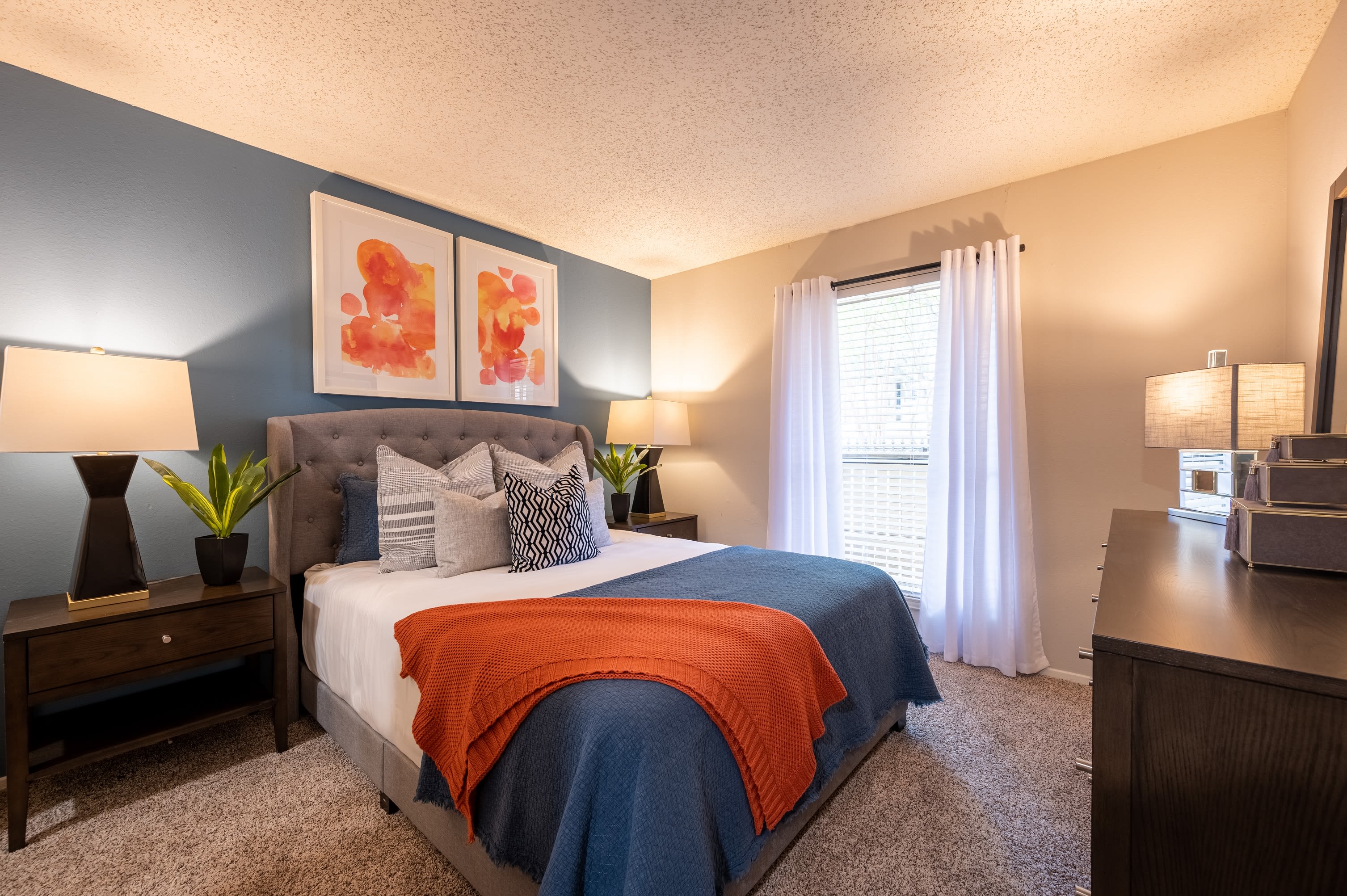 A well decorated model bedroom at Canopy on Central in Bedford, Texas