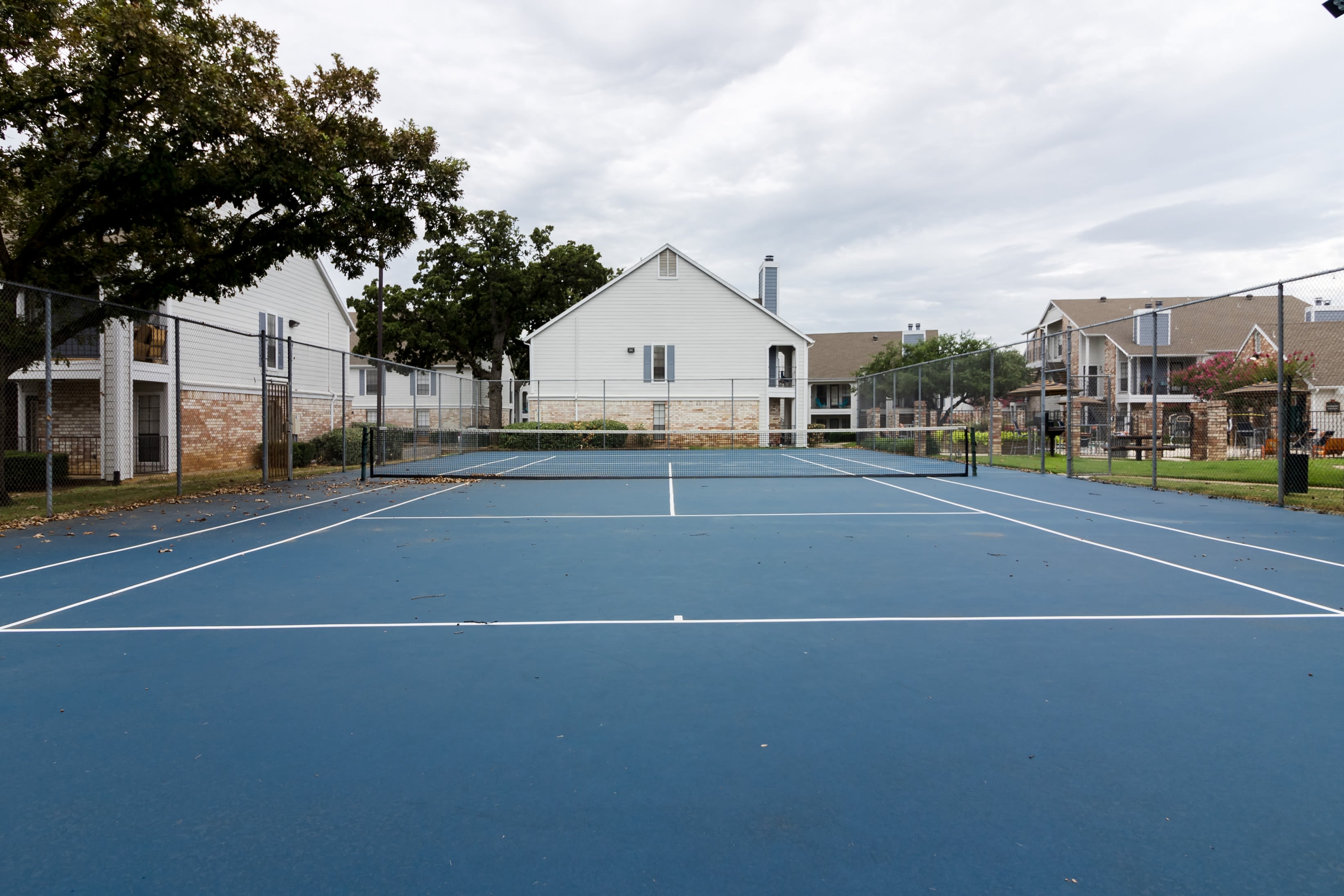 Tennis court for residents at The Logan in Bedford, Texas