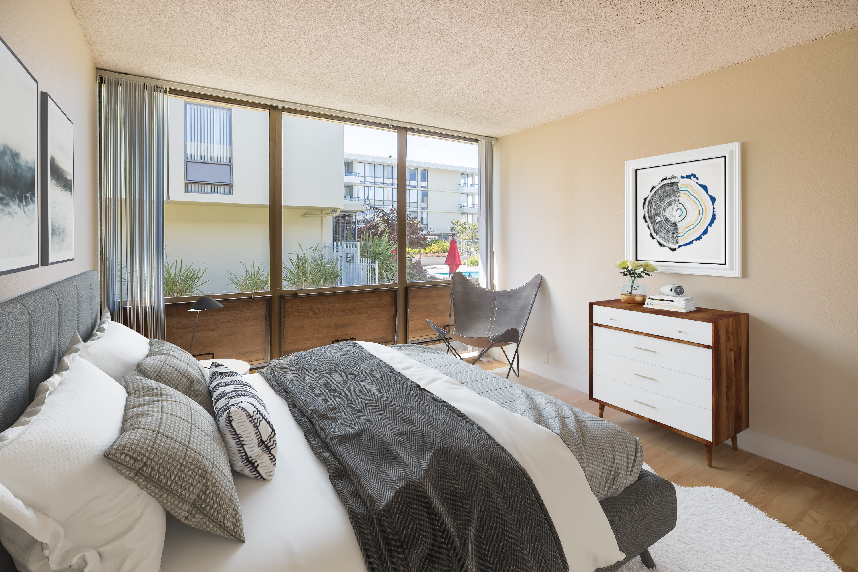Large windows supply this bedroom at Skyline Terrace Apartments in Burlingame, California with lots of natural light 