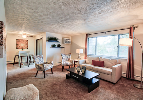 Living room at Webster Manor Apartments home in Webster, New York