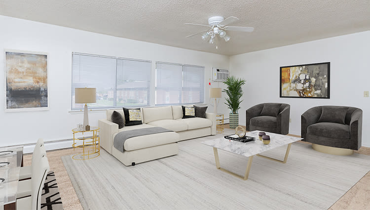 Spacious living room with a ceiling fan at Creek Hill Apartments in Webster, New York