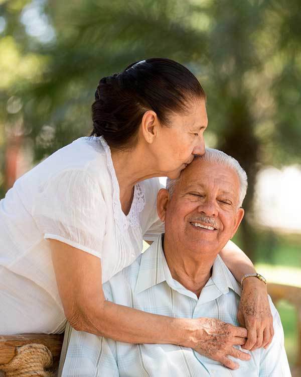 A resident couple hugging and kissing at The Stilley House Senior Living in Benton, Kentucky. 