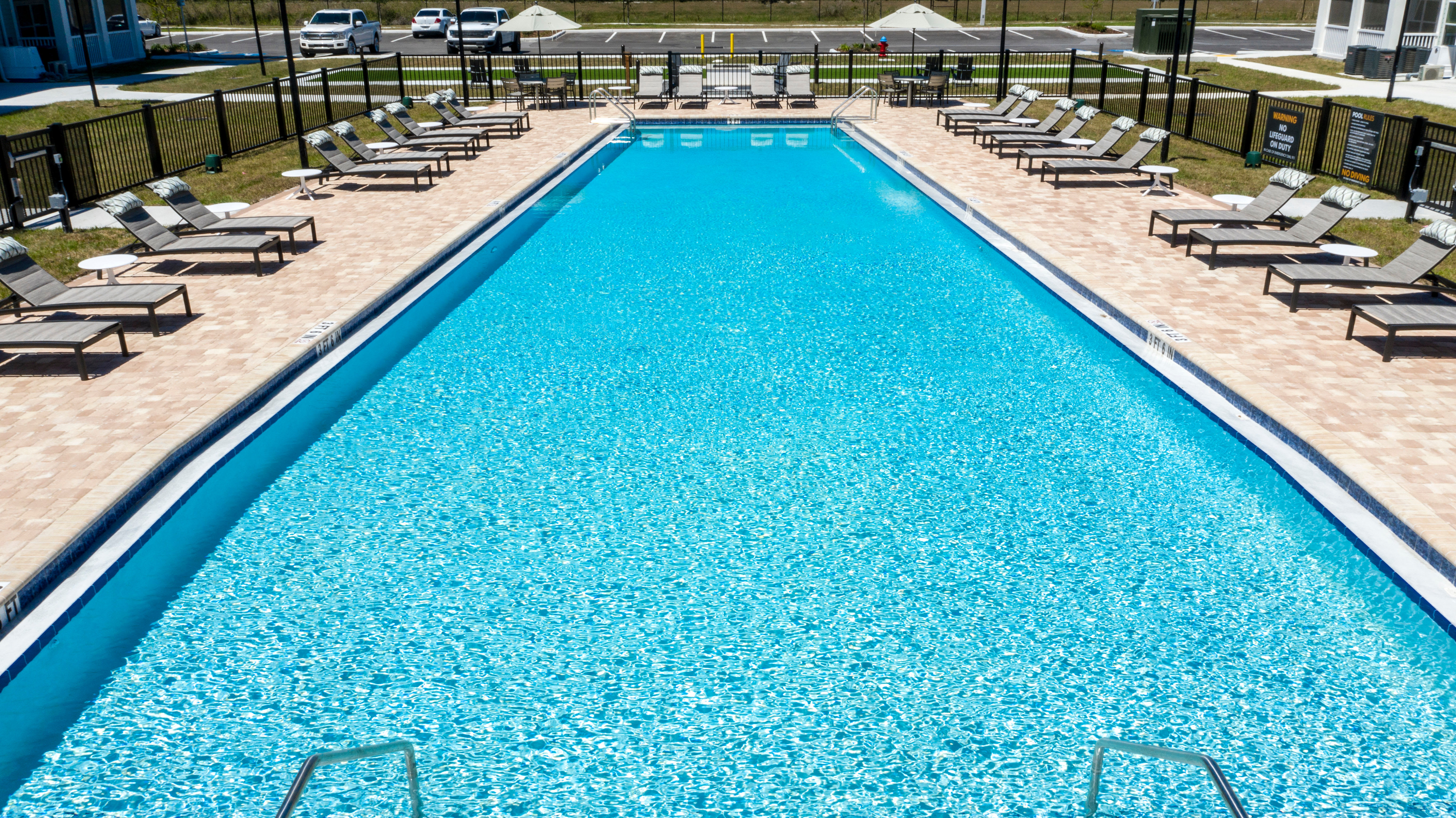 Swimming pool area on a beautiful day at Parc at Wesley Chapel in Wesley Chapel, Florida