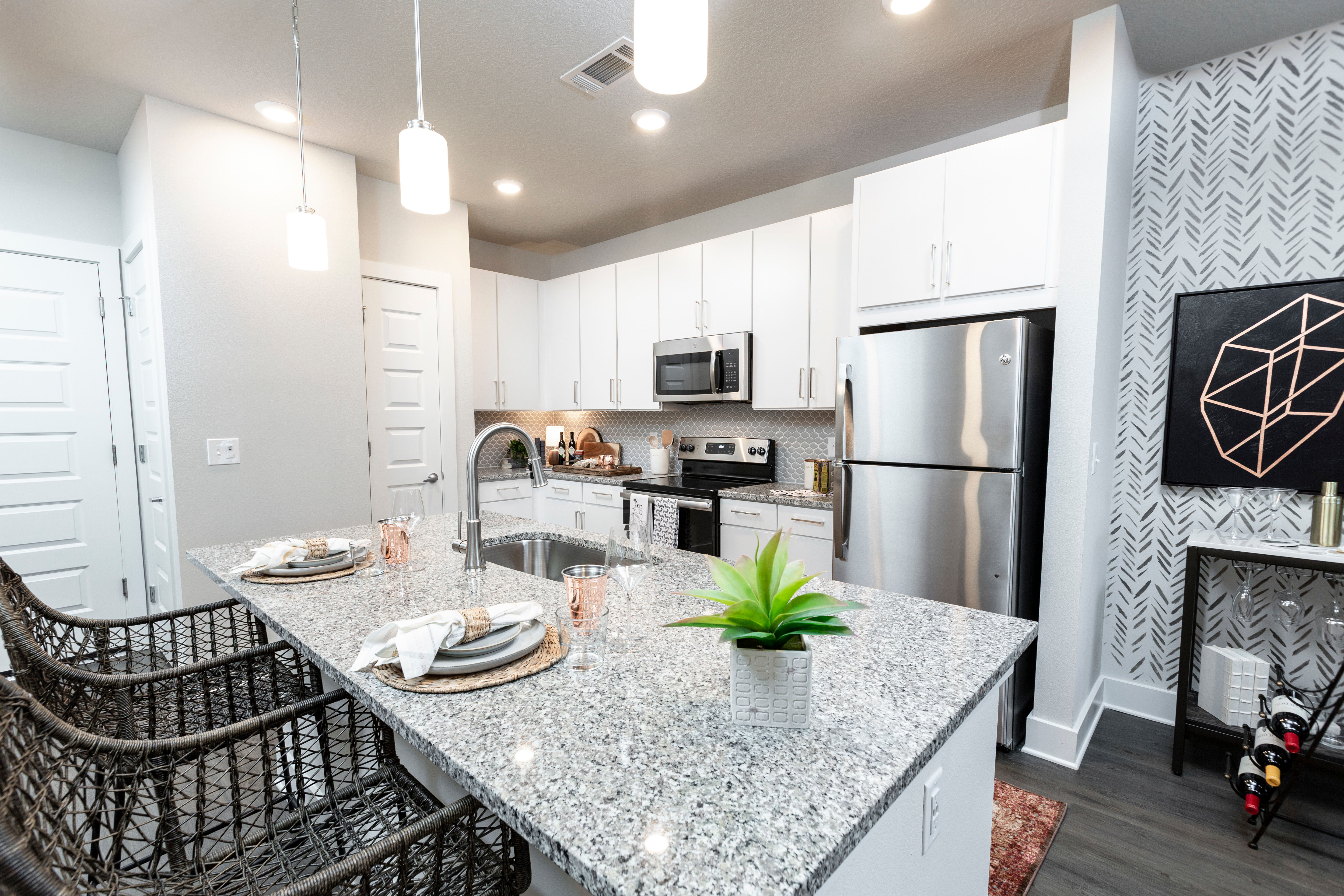 Beautiful open-concept home with a chef-inspired kitchen and hardwood floors at Parc at Wesley Chapel in Wesley Chapel, Florida