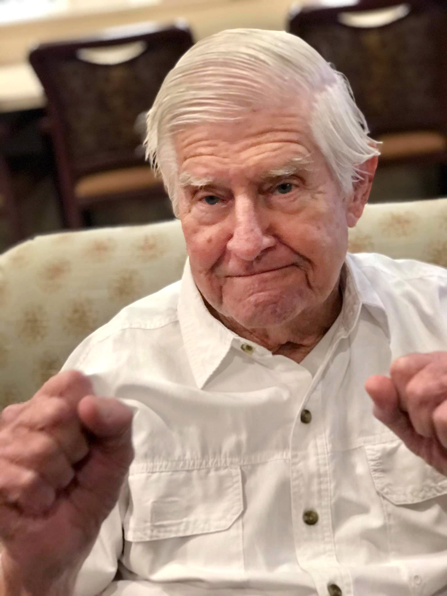 Jovial resident in a white shirt at Oxford Glen Memory Care at Carrollton in Carrollton, Texas