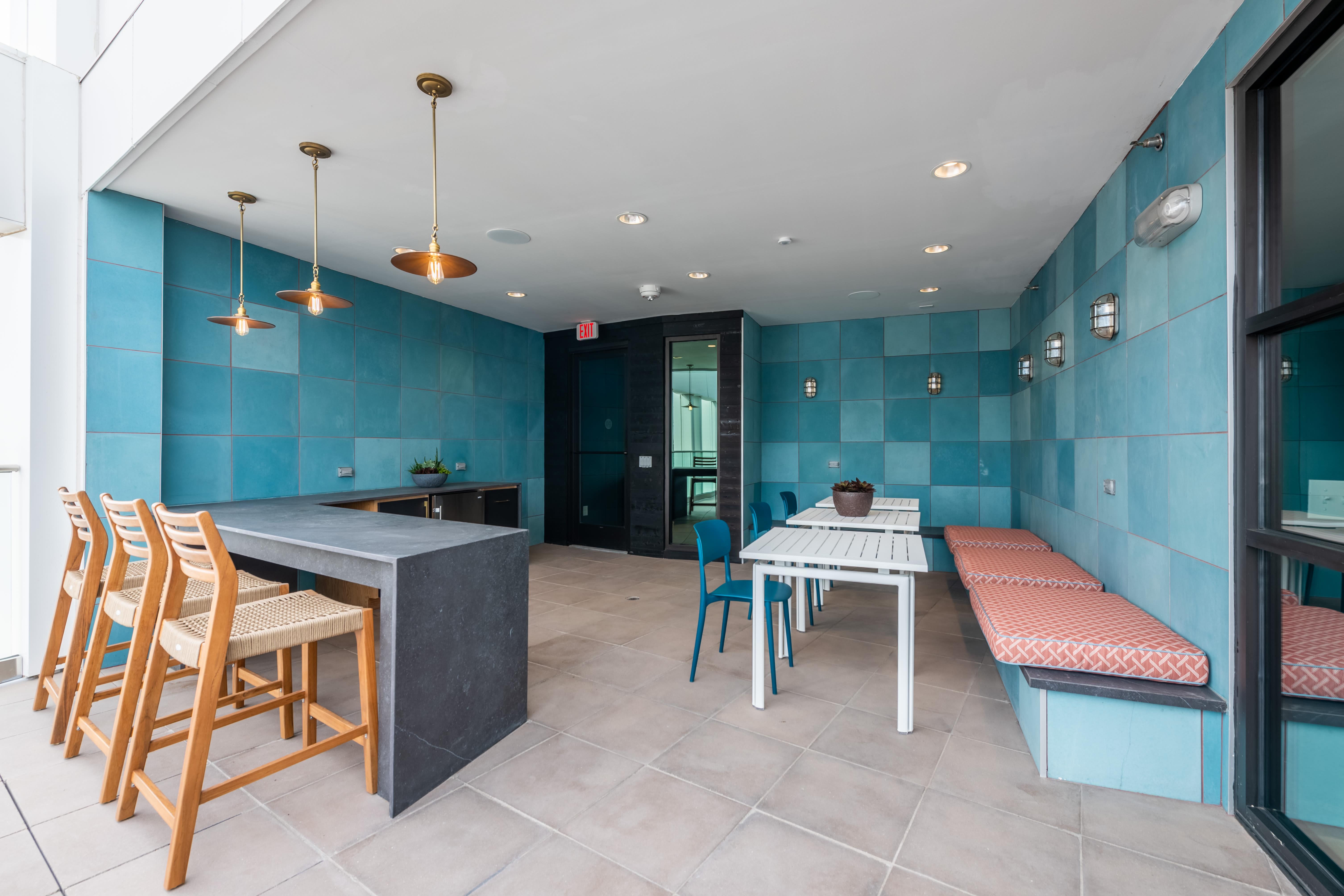 Outdoor community area with blue tile walls at The Langford in Dallas, Texas