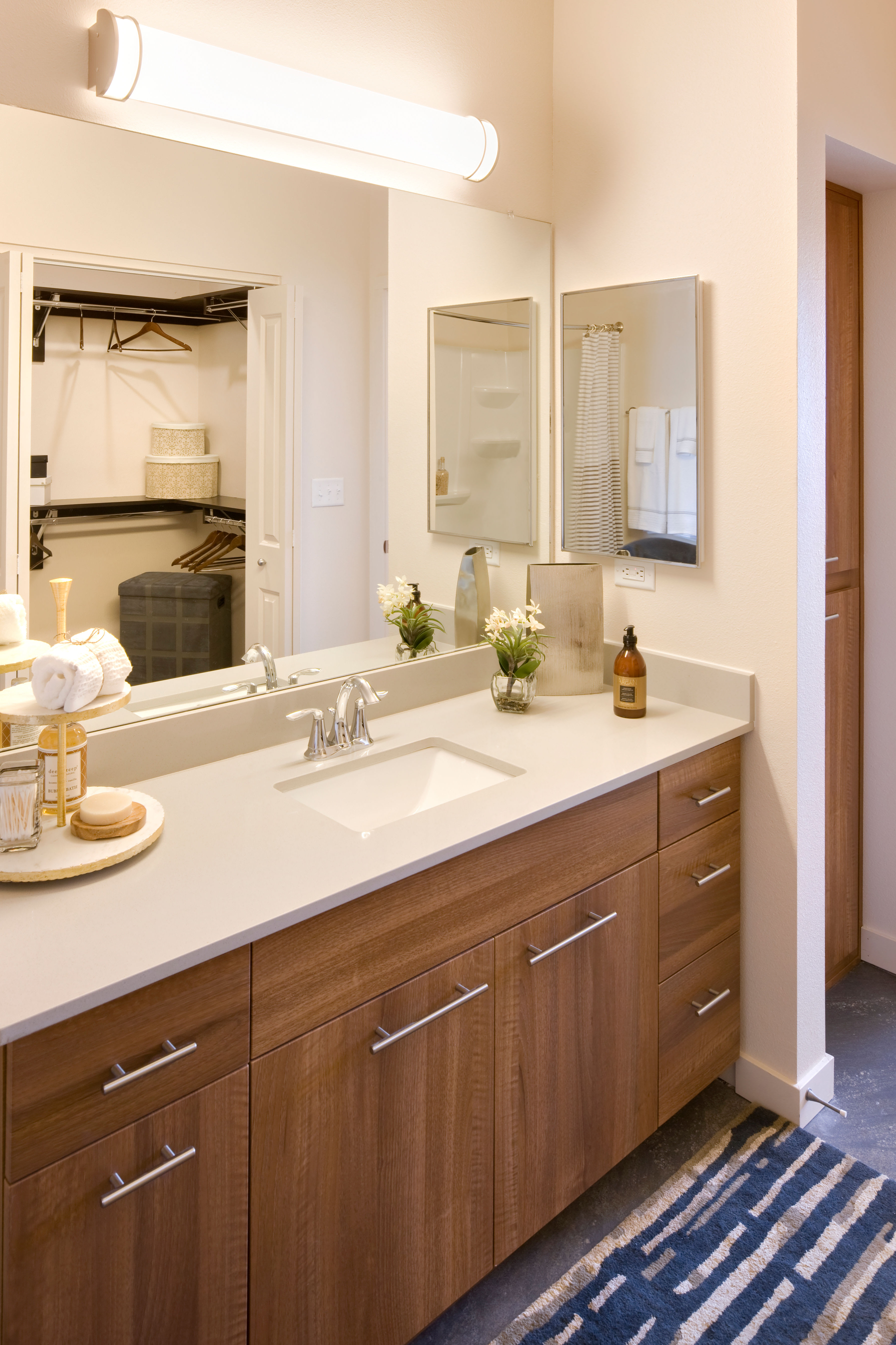 Rich, dark wood cabinetry and stainless-steel appliances in a model home's kitchen at Olympus Alameda in Albuquerque, New Mexico