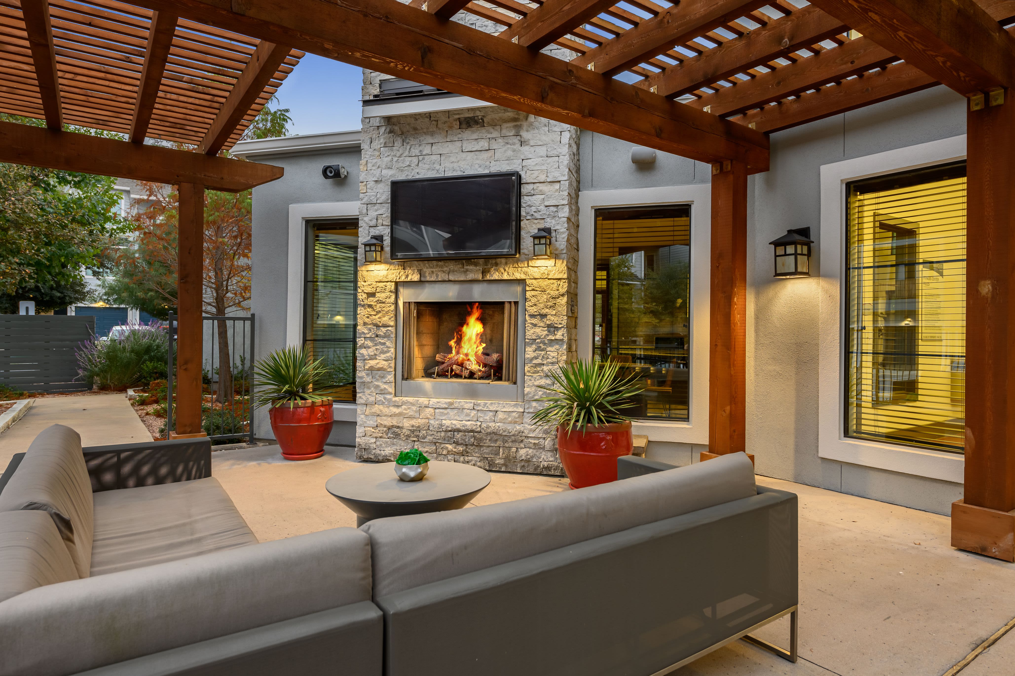 Outdoor patio with TV and couch at Marquis SoCo in Austin, Texas