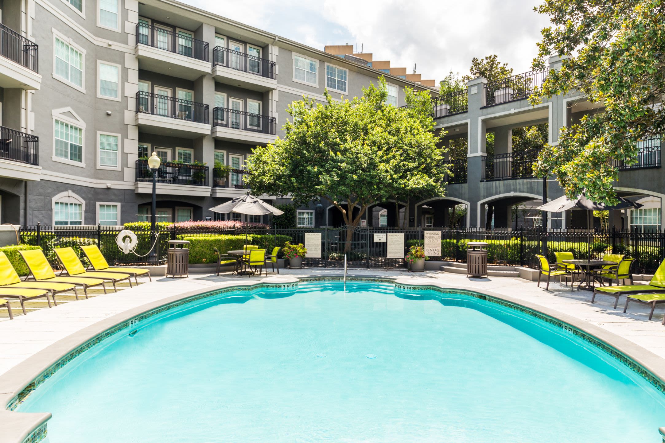 Swimming pool with apartments behind at Marquis at Tanglewood in Houston, Texas