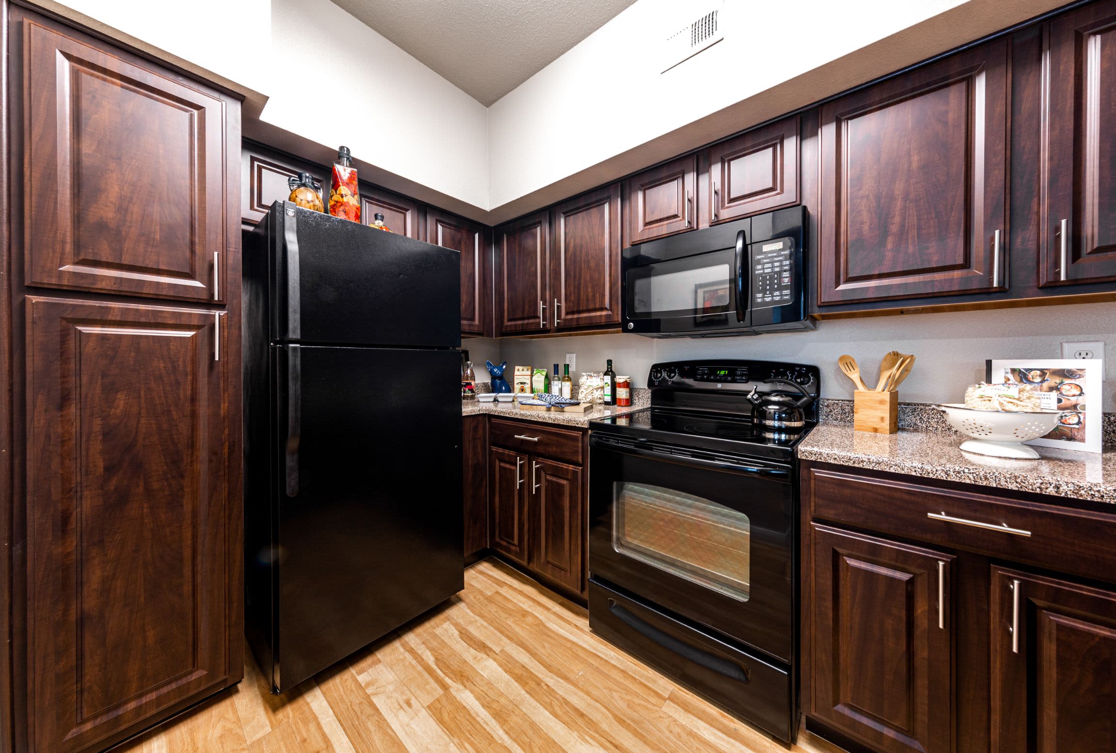 Kitchen with black appliances at Marquis at Westchase in Houston, Texas