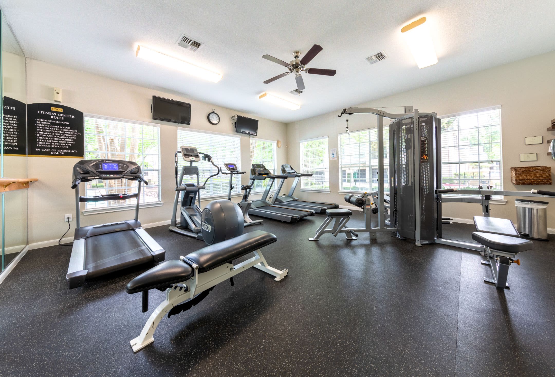 Fitness center with cardio and weight machines at Marquis at Westchase in Houston, Texas