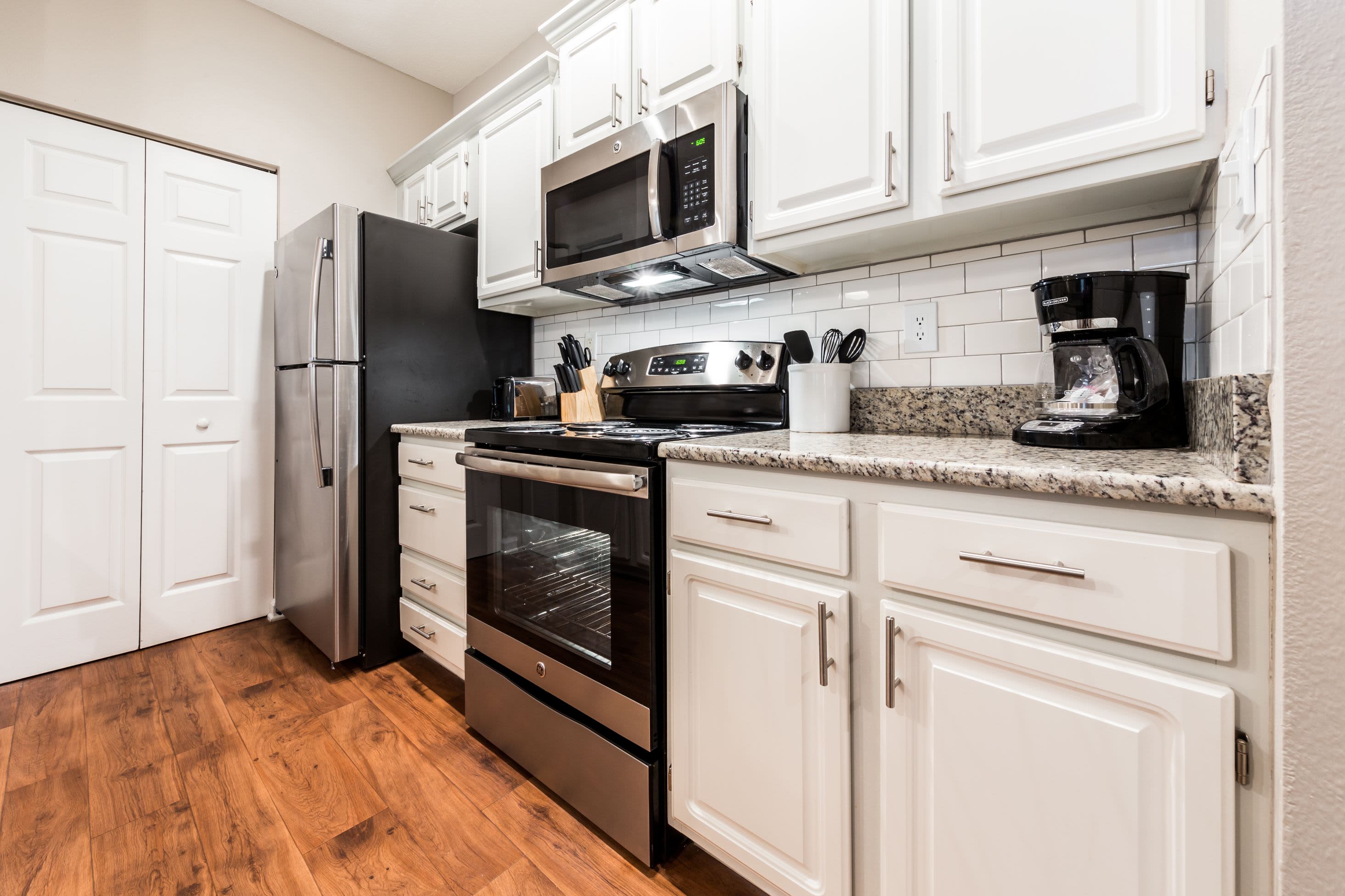 Modern kitchen with white cabinets at The Preserve at Ballantyne Commons in Charlotte, North Carolina