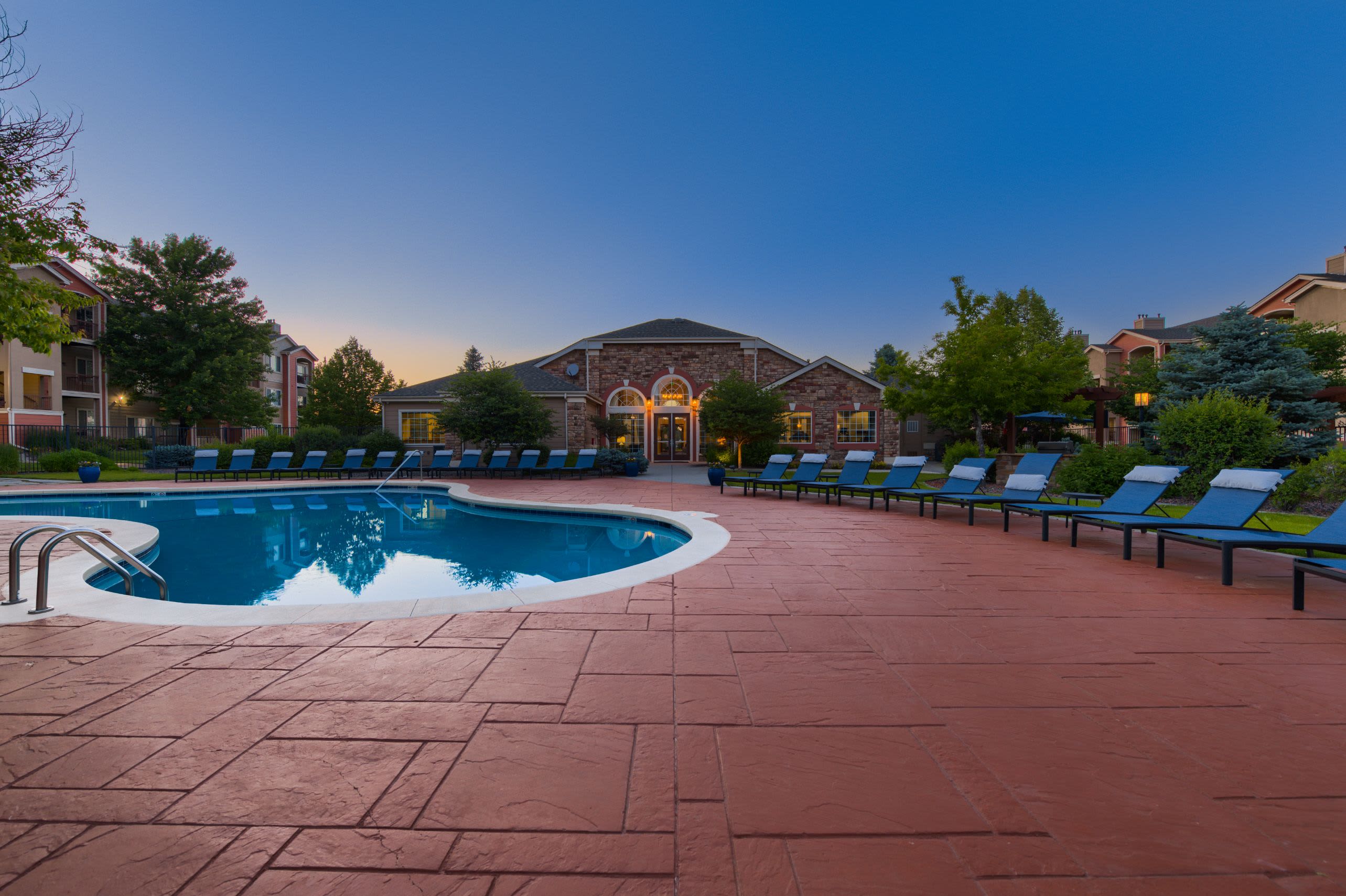 Swimming pool at twilight at Whisper Creek Apartment Homes in Lakewood, Colorado