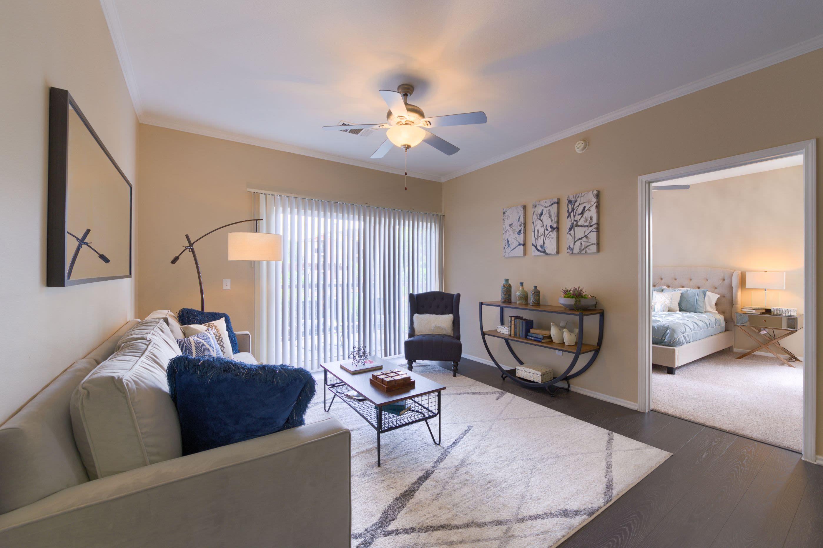 Living room with wood style floors at Whisper Creek Apartment Homes in Lakewood, Colorado