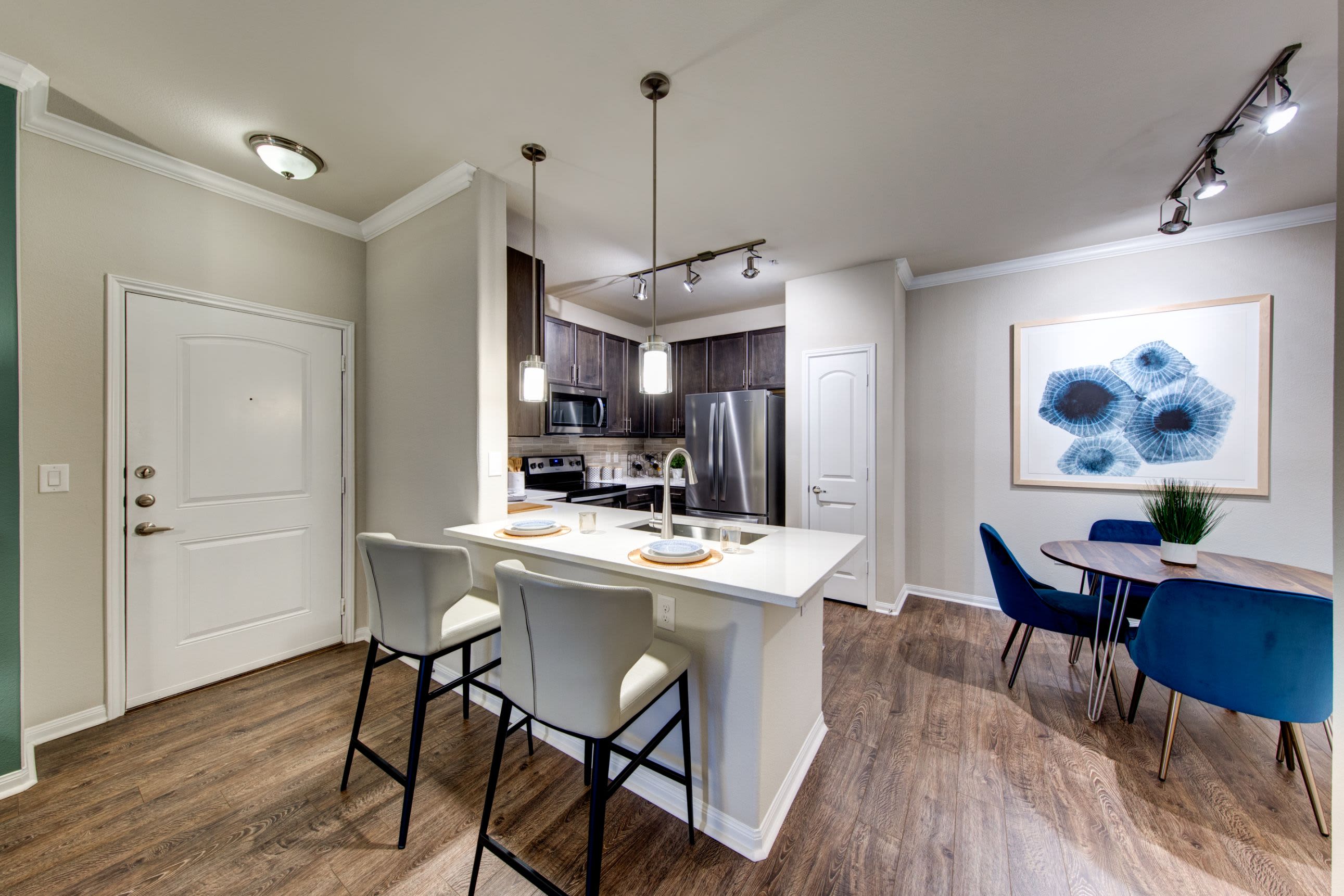 Kitchen with breakfast bar at Marquis at The Woodlands in Spring, Texas