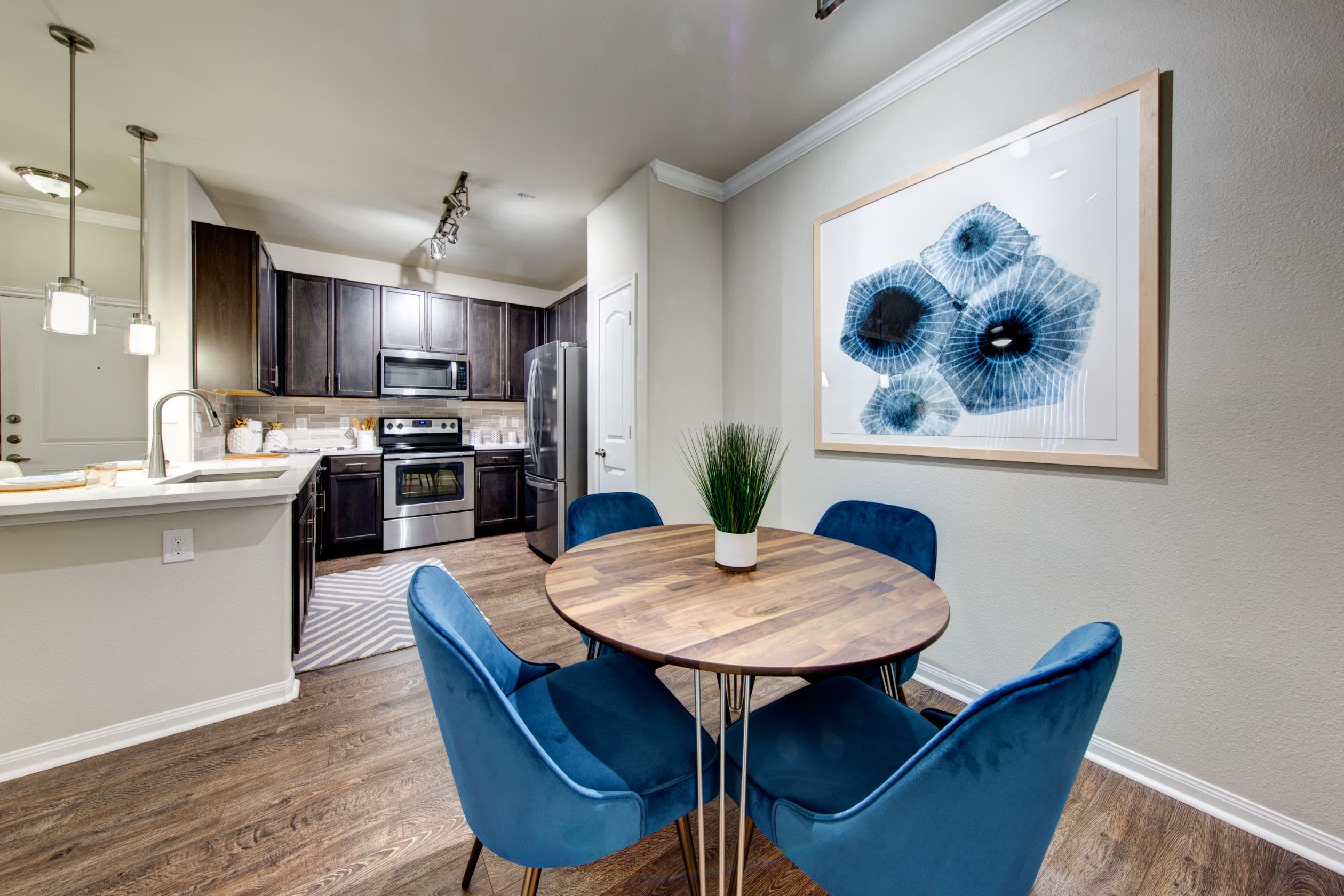 Dining area adjacent to the kitchen at Marquis at The Woodlands in Spring, Texas