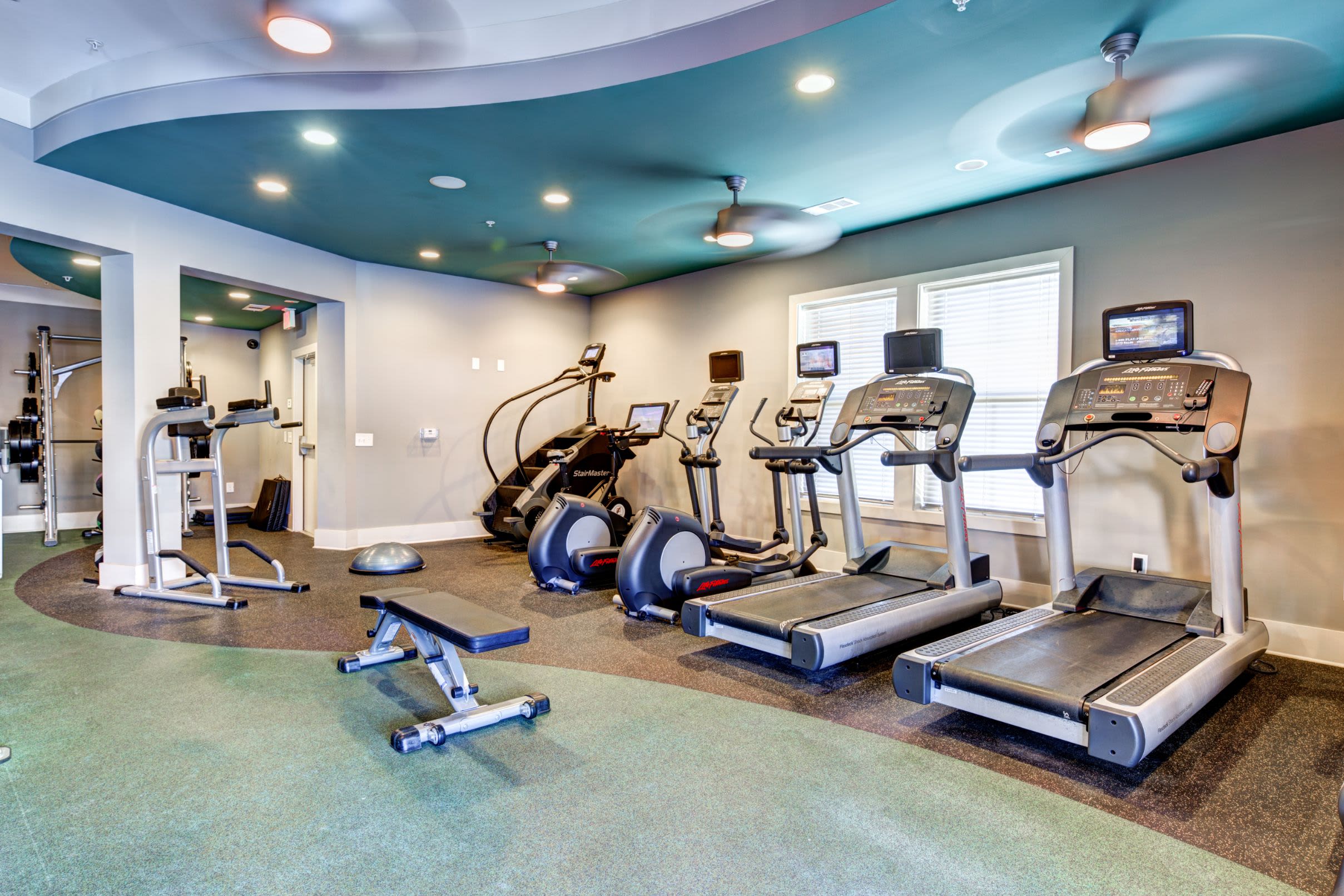 Fitness center with cardio equipment and weights at Marquis at Morrison Plantation in Mooresville, North Carolina