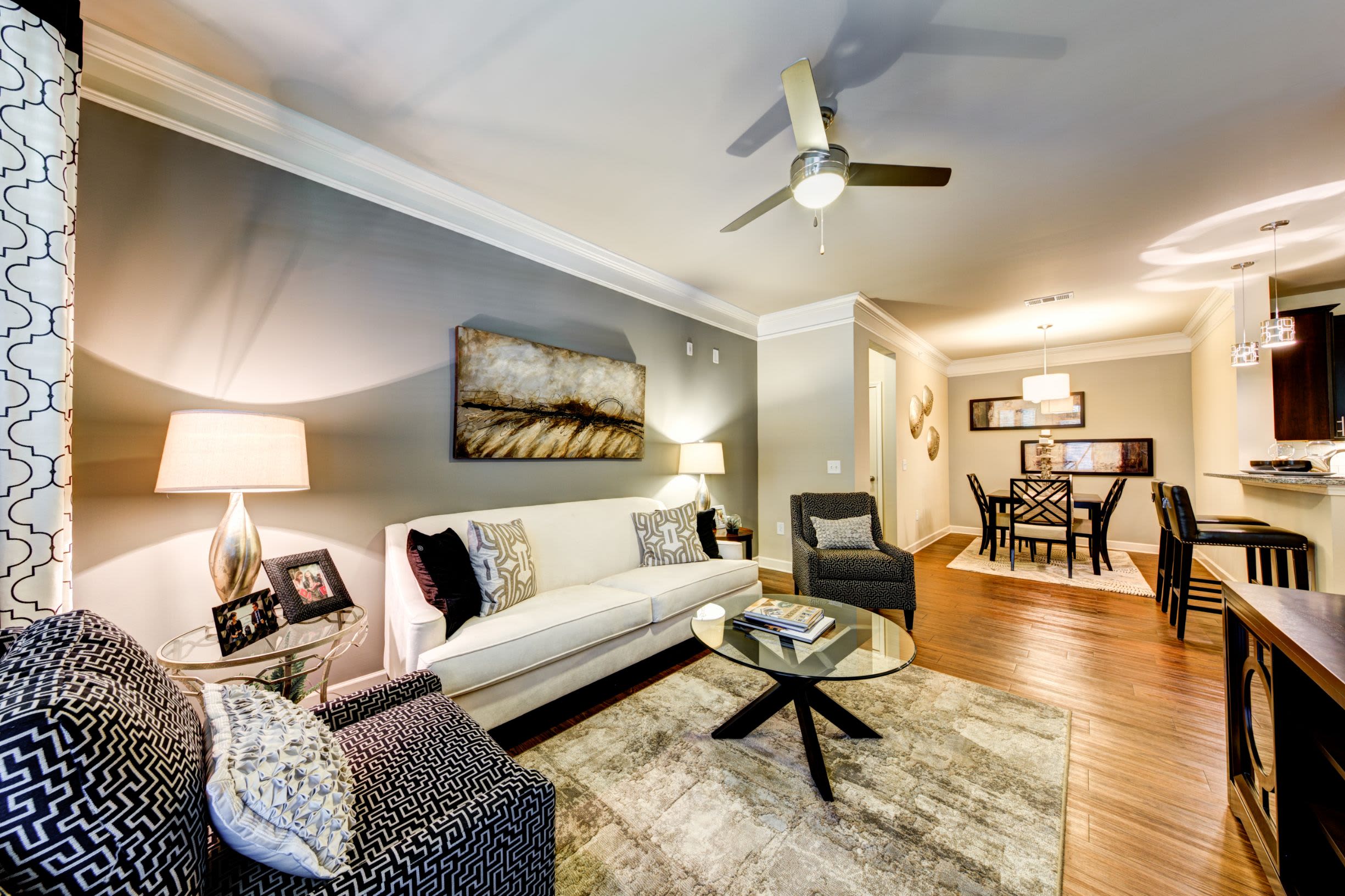 Living room with wood style floors at Marquis at Morrison Plantation in Mooresville, North Carolina