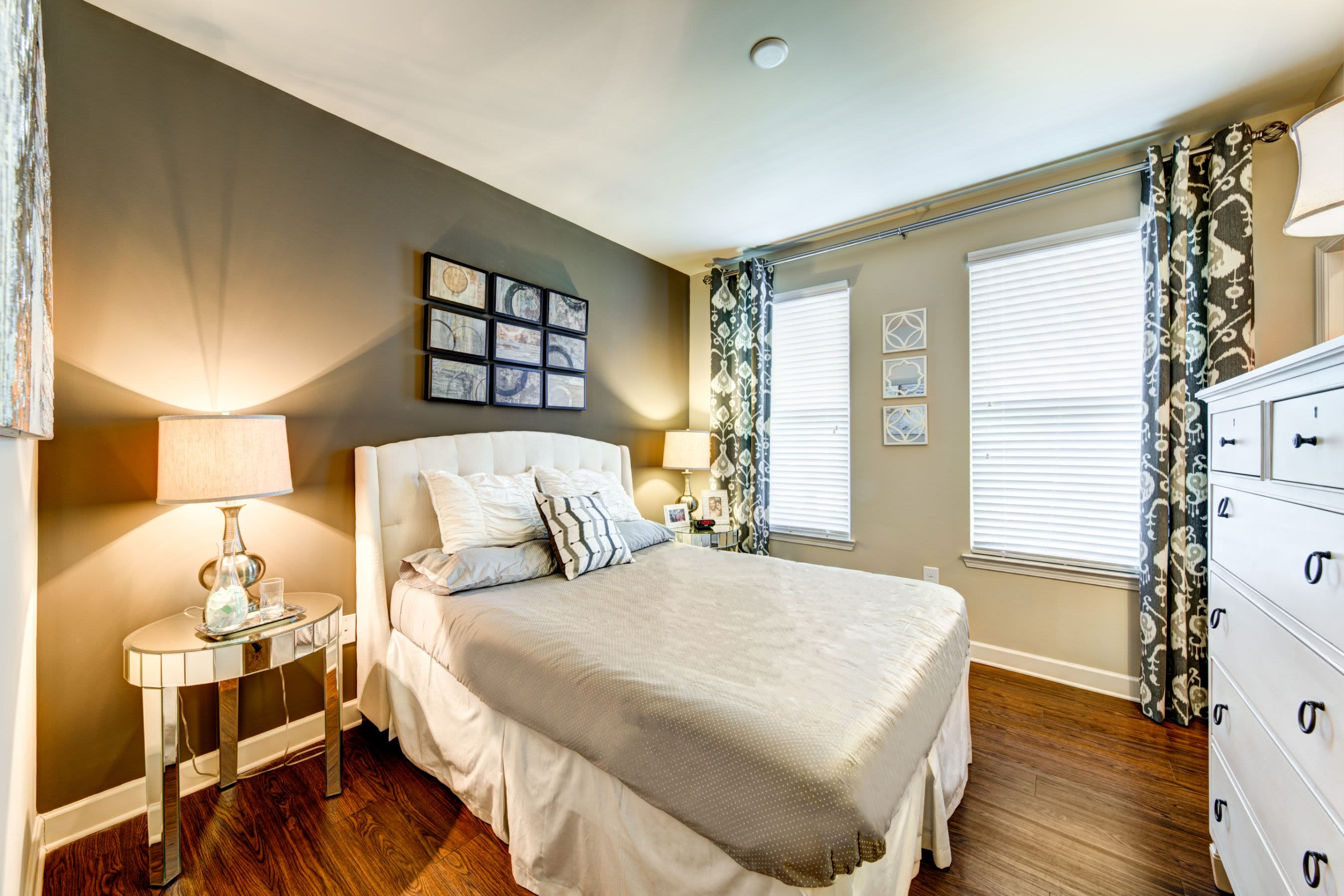 Bedroom with wood style floors at Marquis at Morrison Plantation in Mooresville, North Carolina