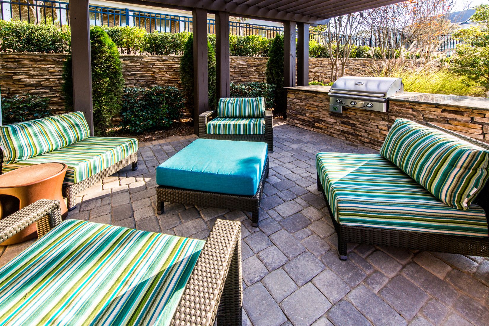Patio furniture next to outdoor grill at Marquis at Morrison Plantation in Mooresville, North Carolina