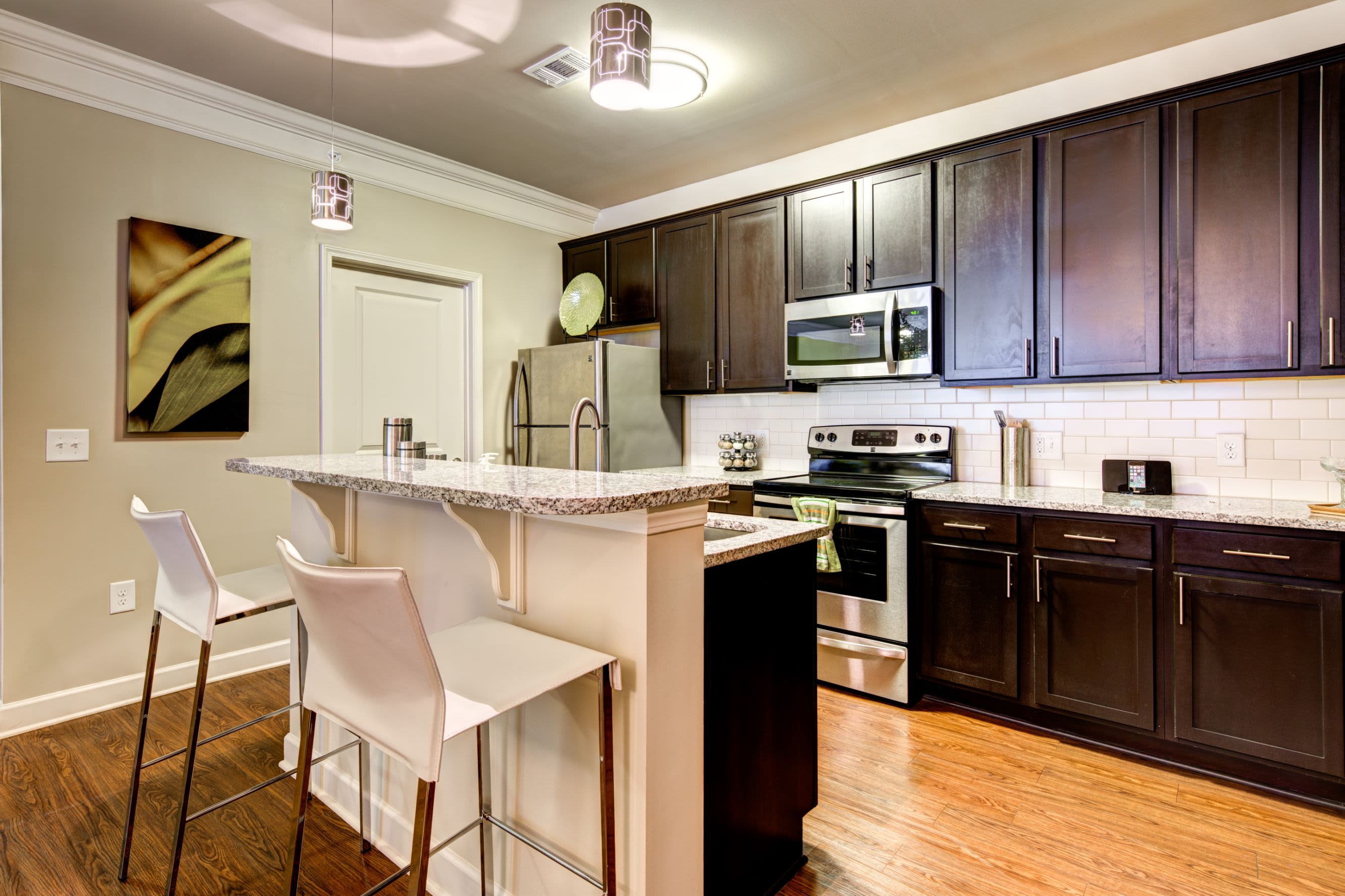 Kitchen with breakfast bar at Marquis at Morrison Plantation in Mooresville, North Carolina