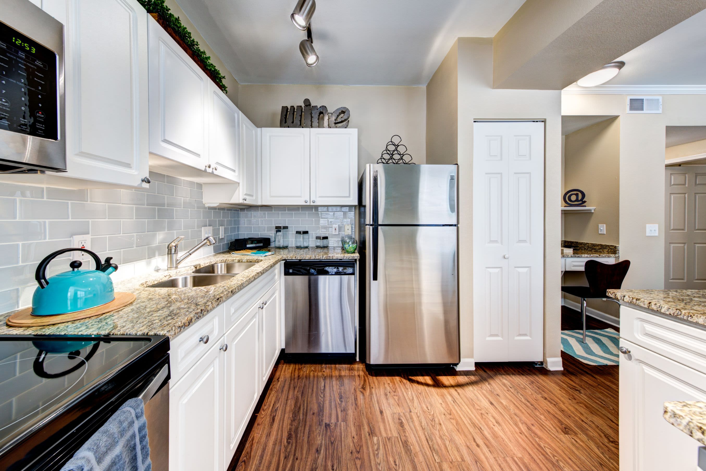 Modern kitchen with white cabinets at Marquis at Town Centre in Broomfield, Colorado