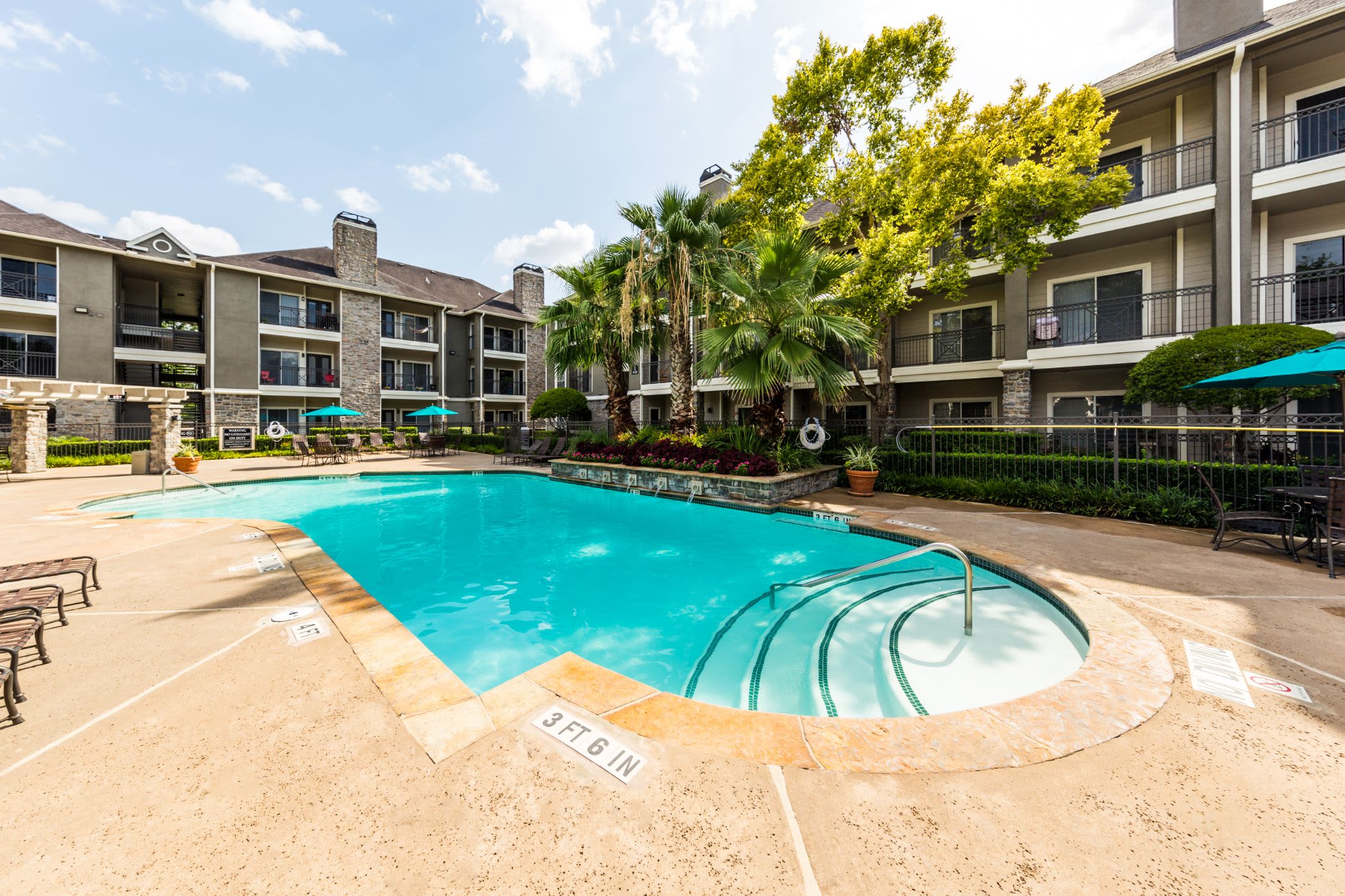Swimming pool with sun chairs at Marquis on Westheimer in Houston, Texas