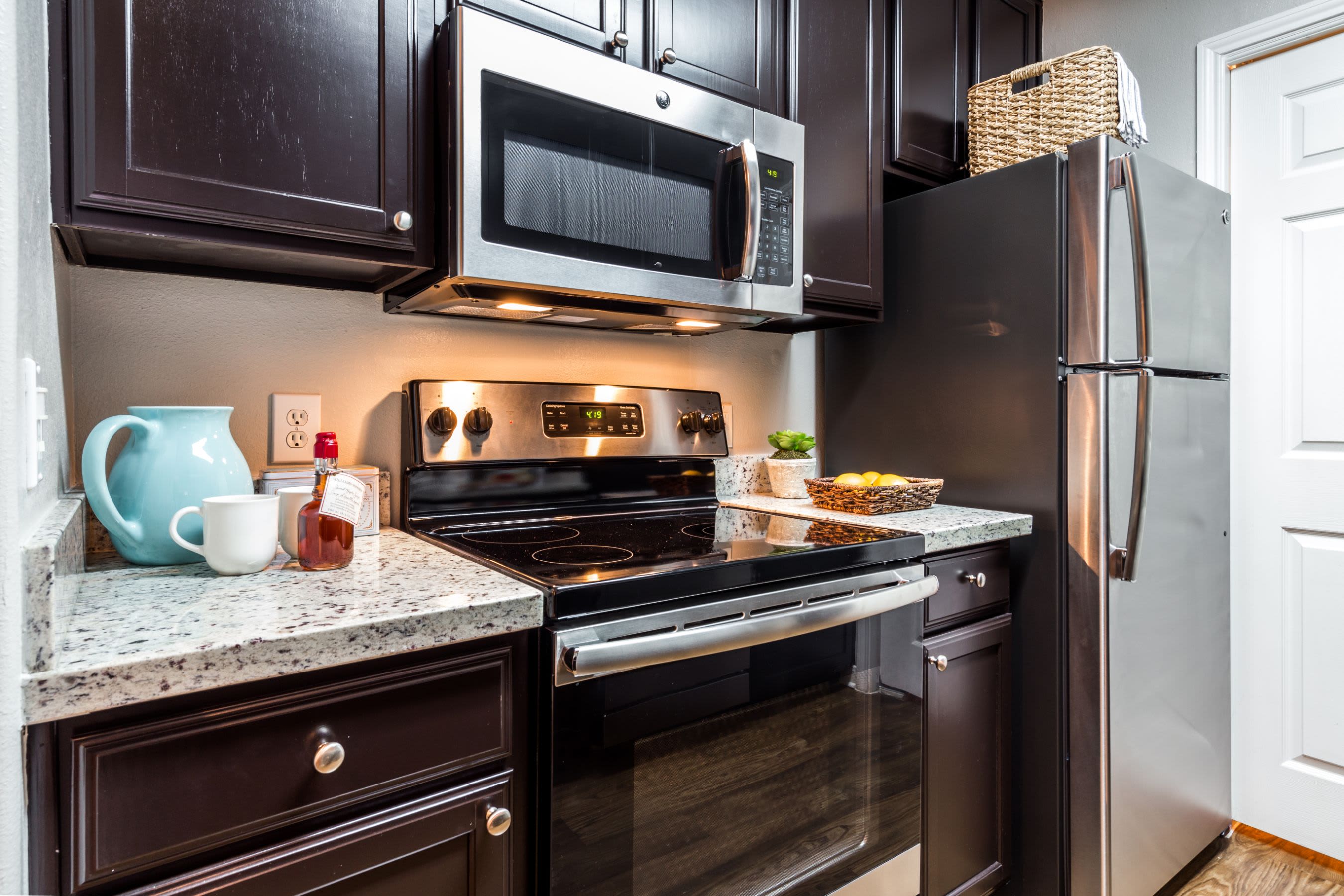 Modern stove and fridge in kitchen at Marquis on Westheimer in Houston, Texas