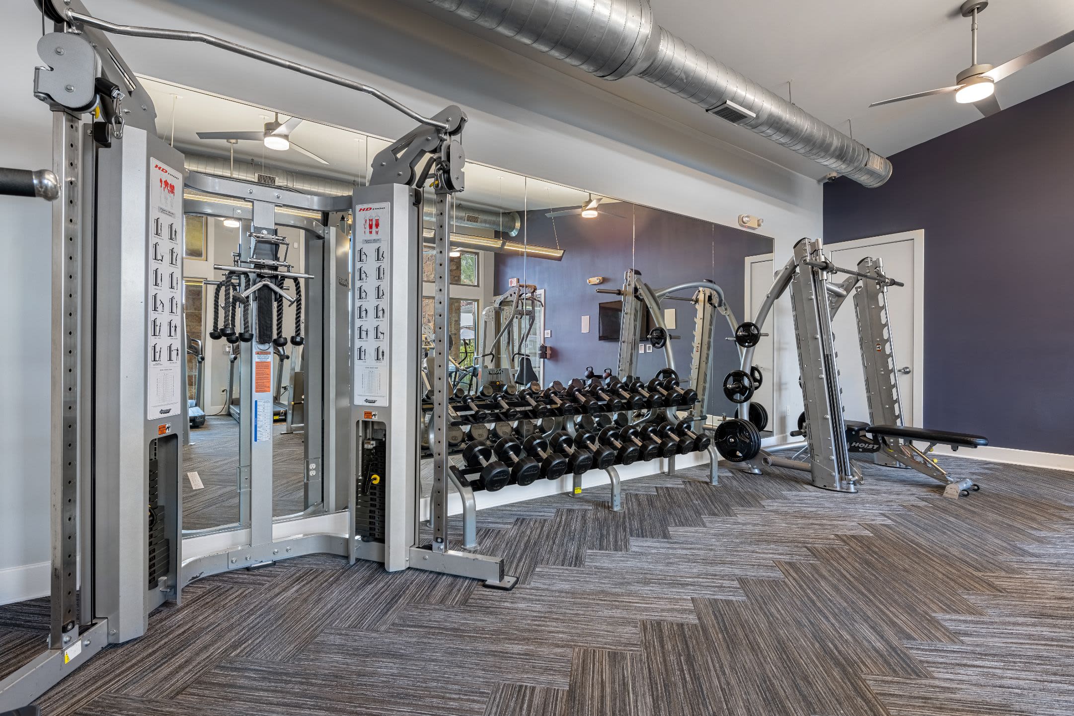 Free weights in fitness center at Marquis Cresta Bella in San Antonio, Texas