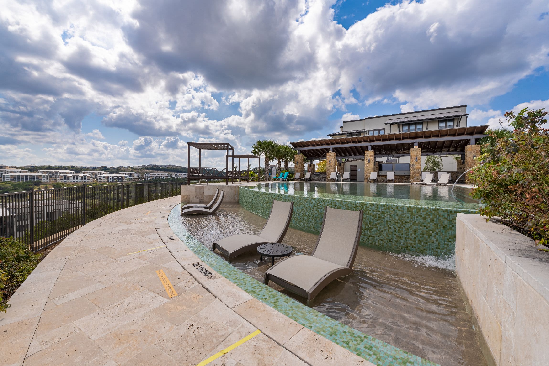 Sun chairs in swimming pool at Marquis Cresta Bella in San Antonio, Texas