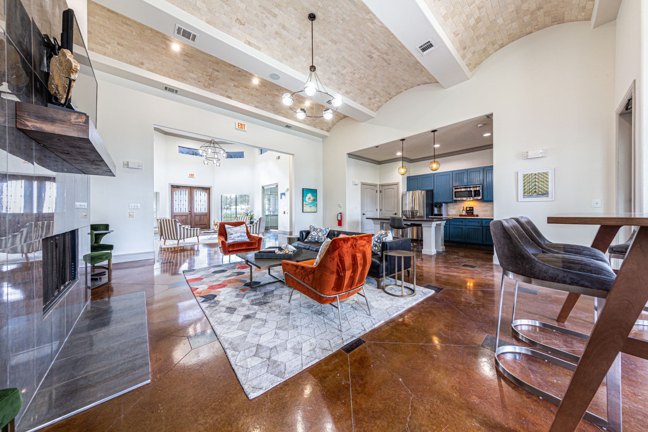 Spacious clubhouse with a large rug at Marquis Grand Lakes in Richmond, Texas