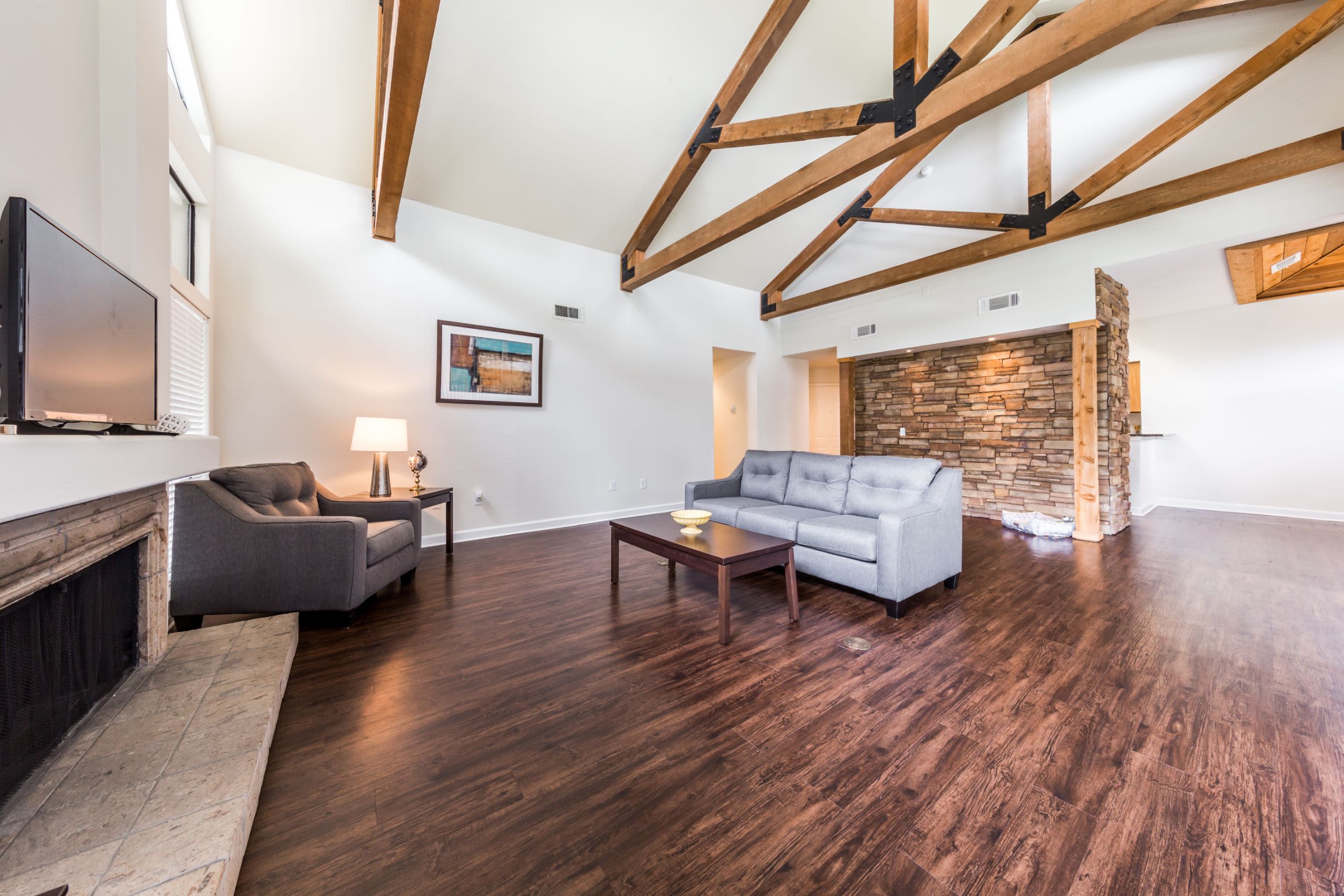 Spacious living room with fireplace at Marquis at Caprock Canyon in Austin, Texas