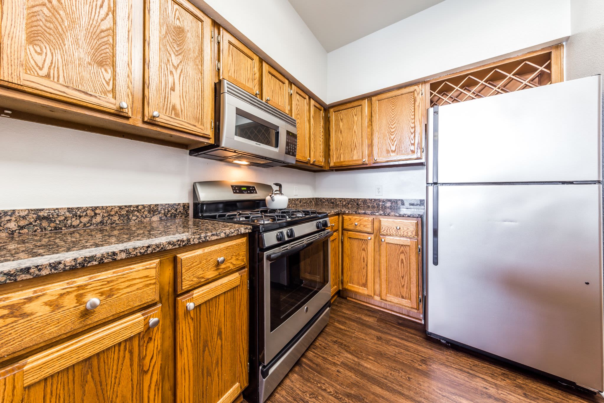 Kitchen with a large fridge at Marquis at Caprock Canyon in Austin, Texas