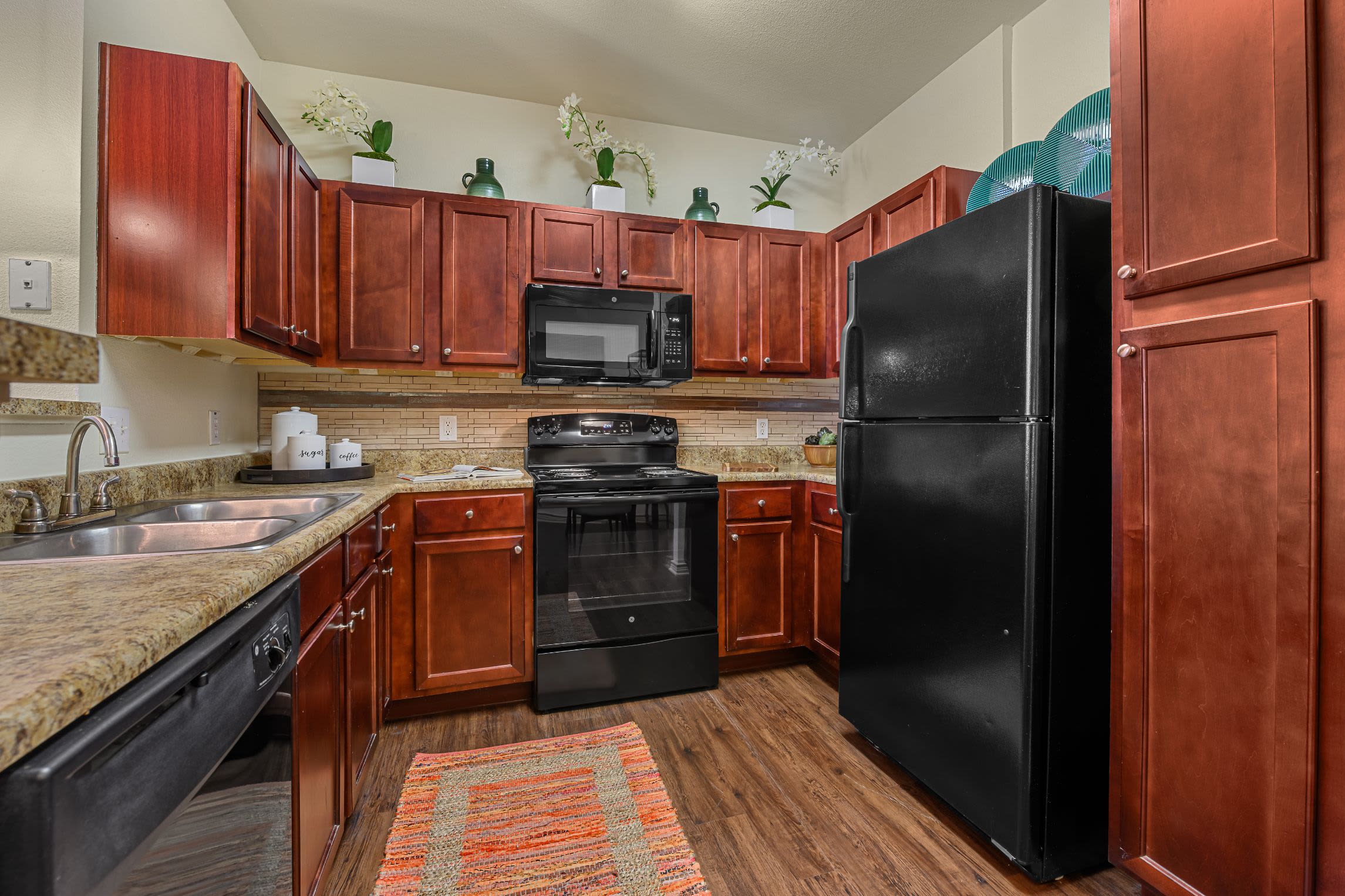 Kitchen with granite style counters at Marquis Lakeline Station in Austin, Texas