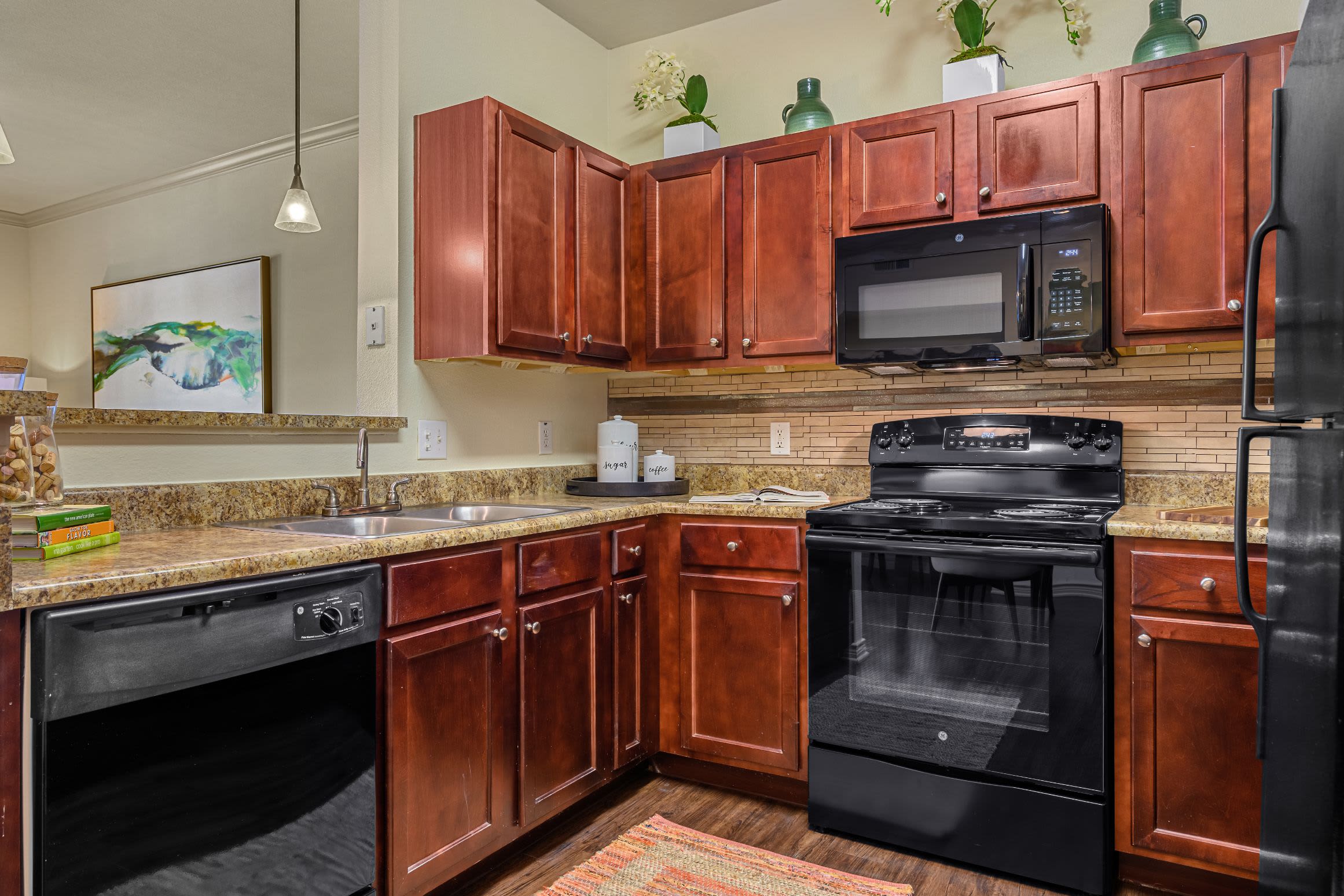 Modern kitchen with black appliances at Marquis Lakeline Station in Austin, Texas