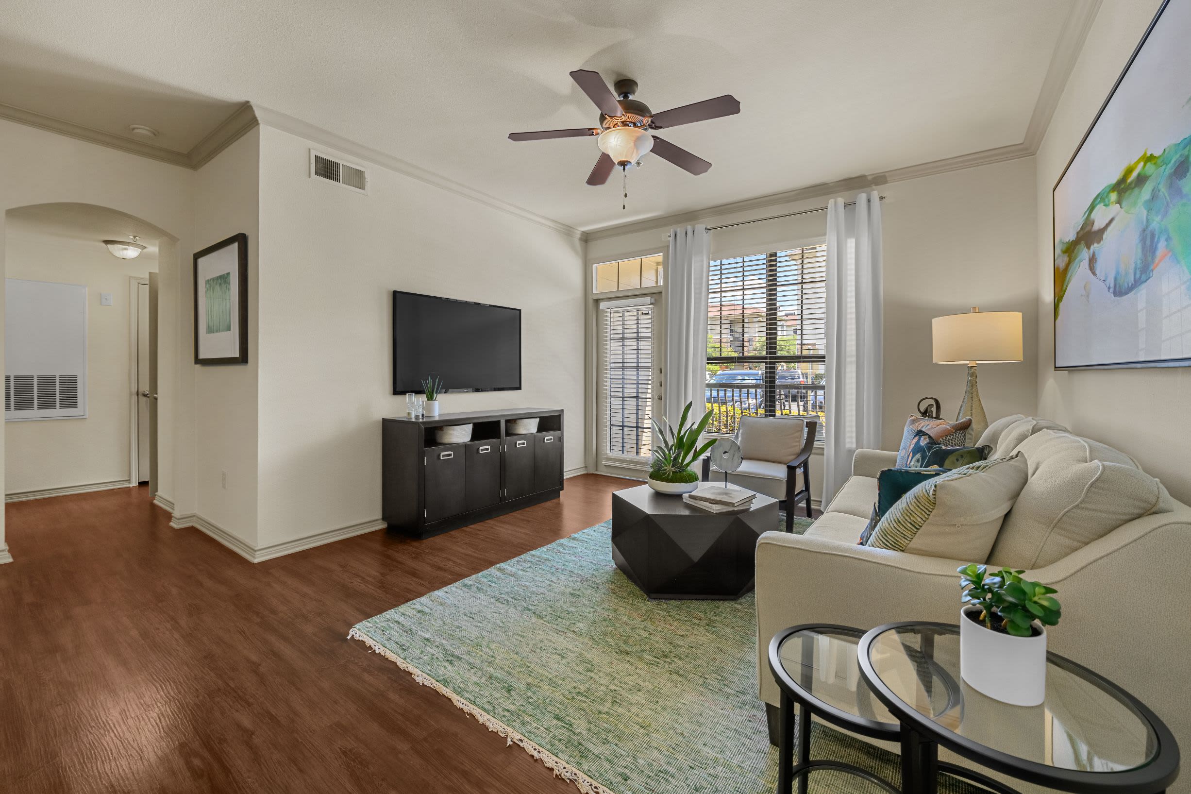 Living room with large rug and wood style floors at Marquis Lakeline Station in Austin, Texas